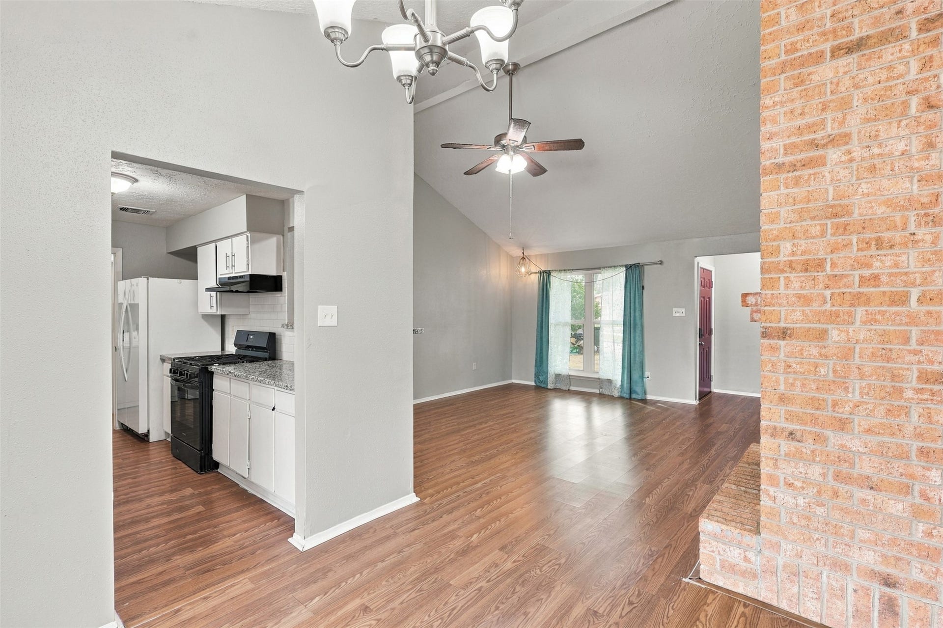 3011 Helmsley Drive, Pearland, TX 77584 Conveniently positioned dining area connects the kitchen and living room, with the brick fireplace adding warmth and character.
