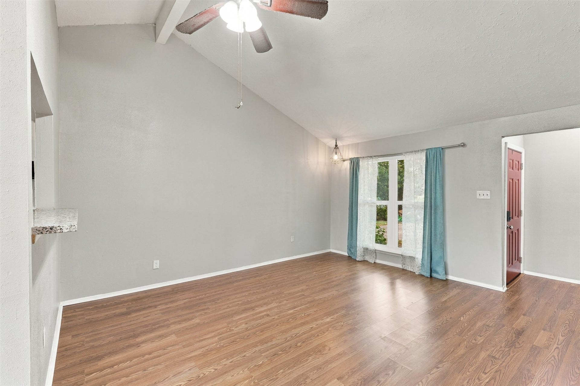 3011 Helmsley Drive, Pearland, TX 77584 Another view of the living room highlights the high ceiling, wood-look flooring, and front windos.