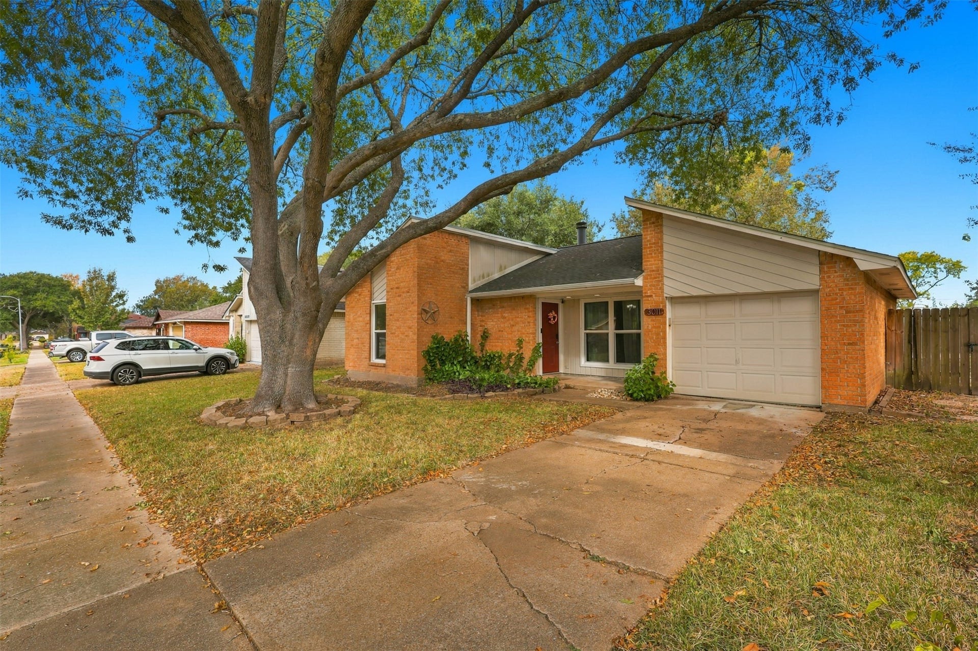 3011 Helmsley Drive, Pearland, TX 77584 Driveway that leads to the attached garage, with a walkway connecting to the covered front entry.