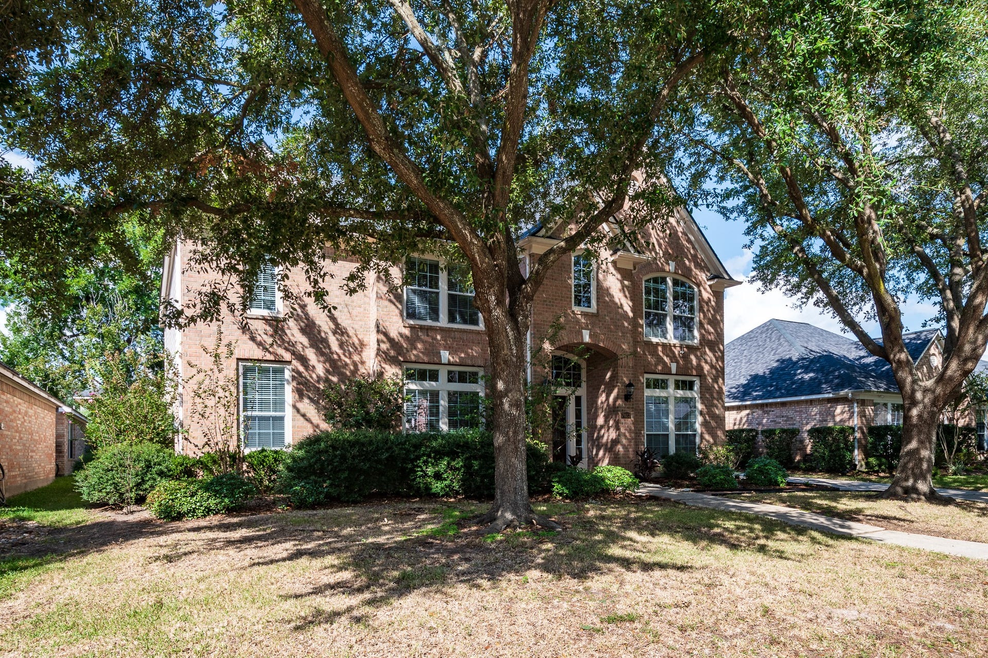 7023 Timber Edge Lane Lane, Humble, TX 77346 Font Elevation with mature trees and landscaping.