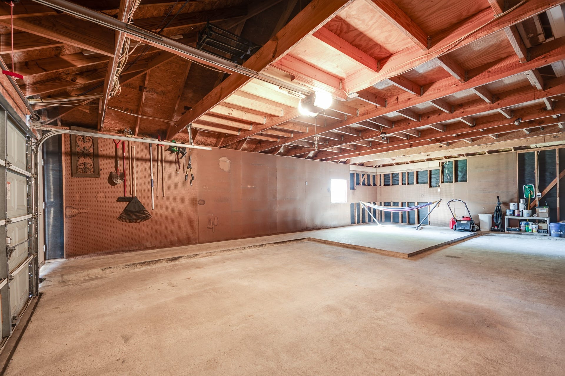7023 Timber Edge Lane Lane, Humble, TX 77346 Garage with high ceilings, ample storage, and a versatile work area, perfect for projects and parking.