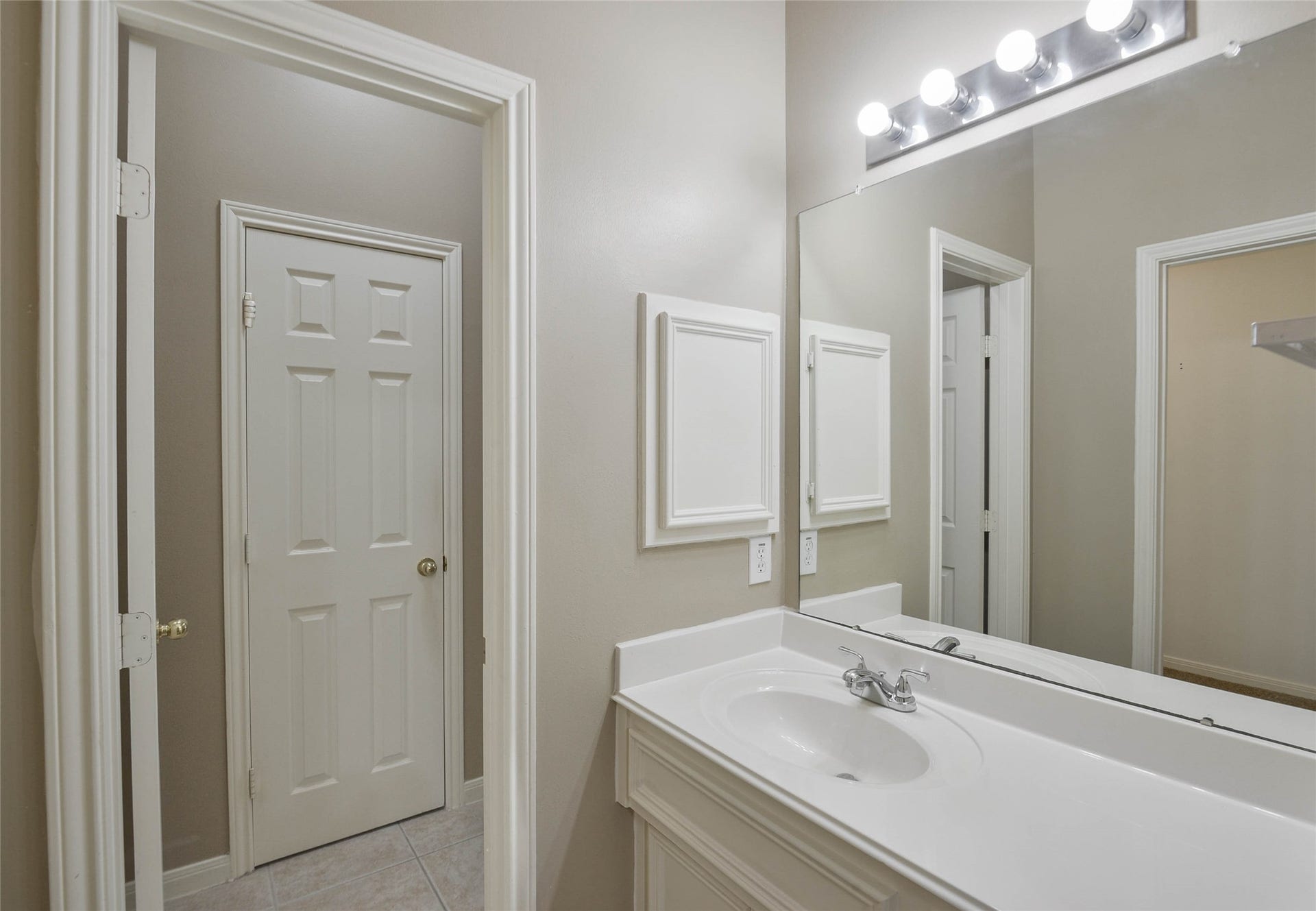 7023 Timber Edge Lane Lane, Humble, TX 77346 Bright and inviting bathroom featuring a large mirror, modern lighting, and a sleek vanity with ample storage.