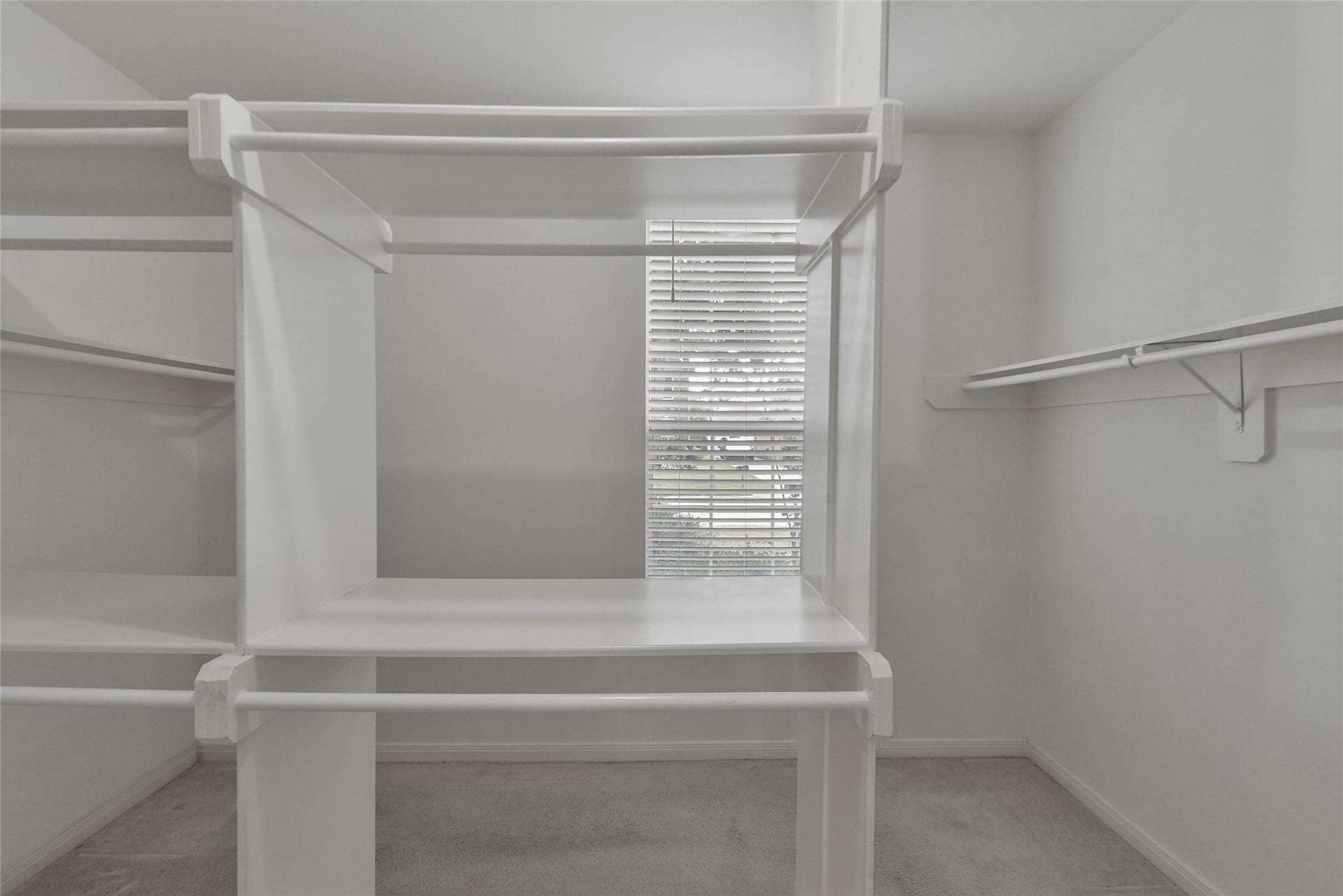 7023 Timber Edge Lane Lane, Humble, TX 77346 Walk-in closet featuring ample shelving and hanging space, enhanced by natural light from a well-placed window.