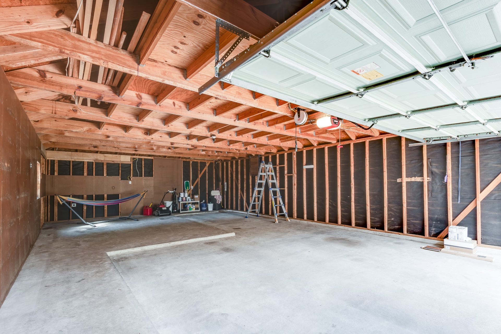 7023 Timber Edge Lane Lane, Humble, TX 77346 Garage with exposed wooden beams and ample storage potential, perfect for customization.