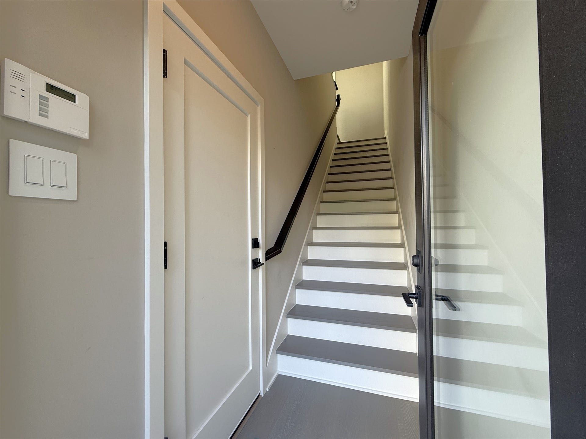 Welcome home! From a glass paned door, natural light flows into entry stairway.