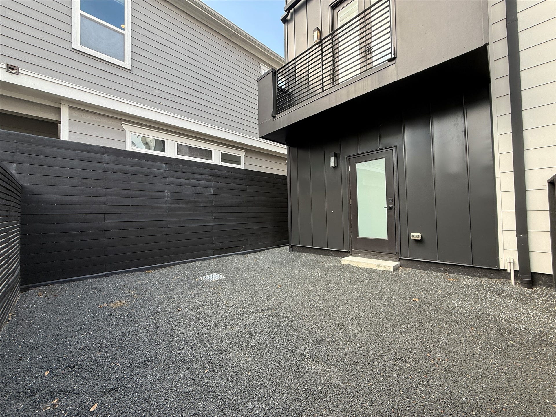 The back yard is spacious enough to accommodate a significant amount of furniture.