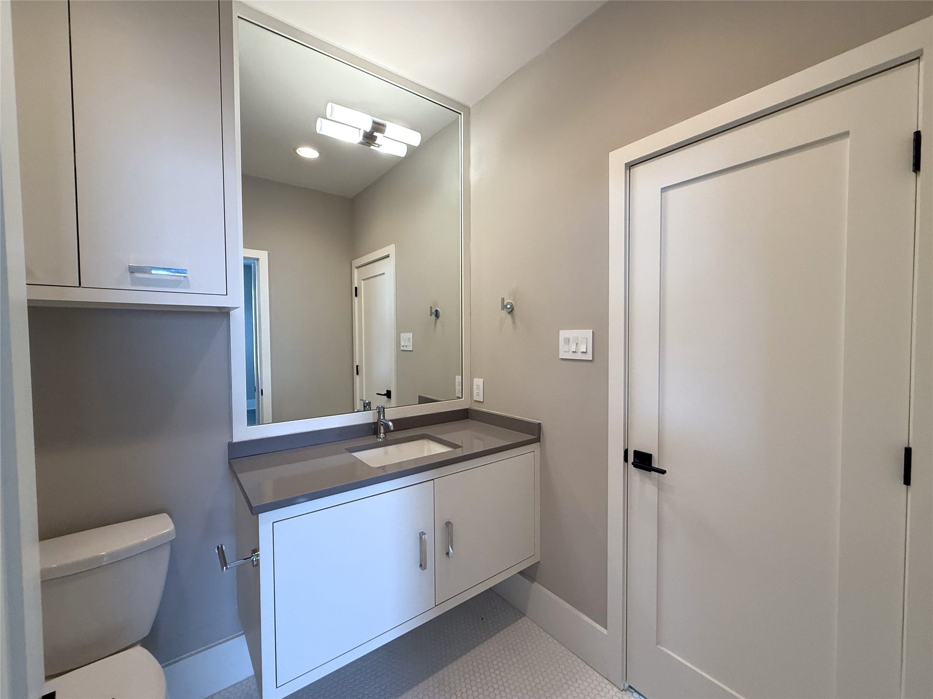 The bathroom offers linen storage and a nicely sized vanity.