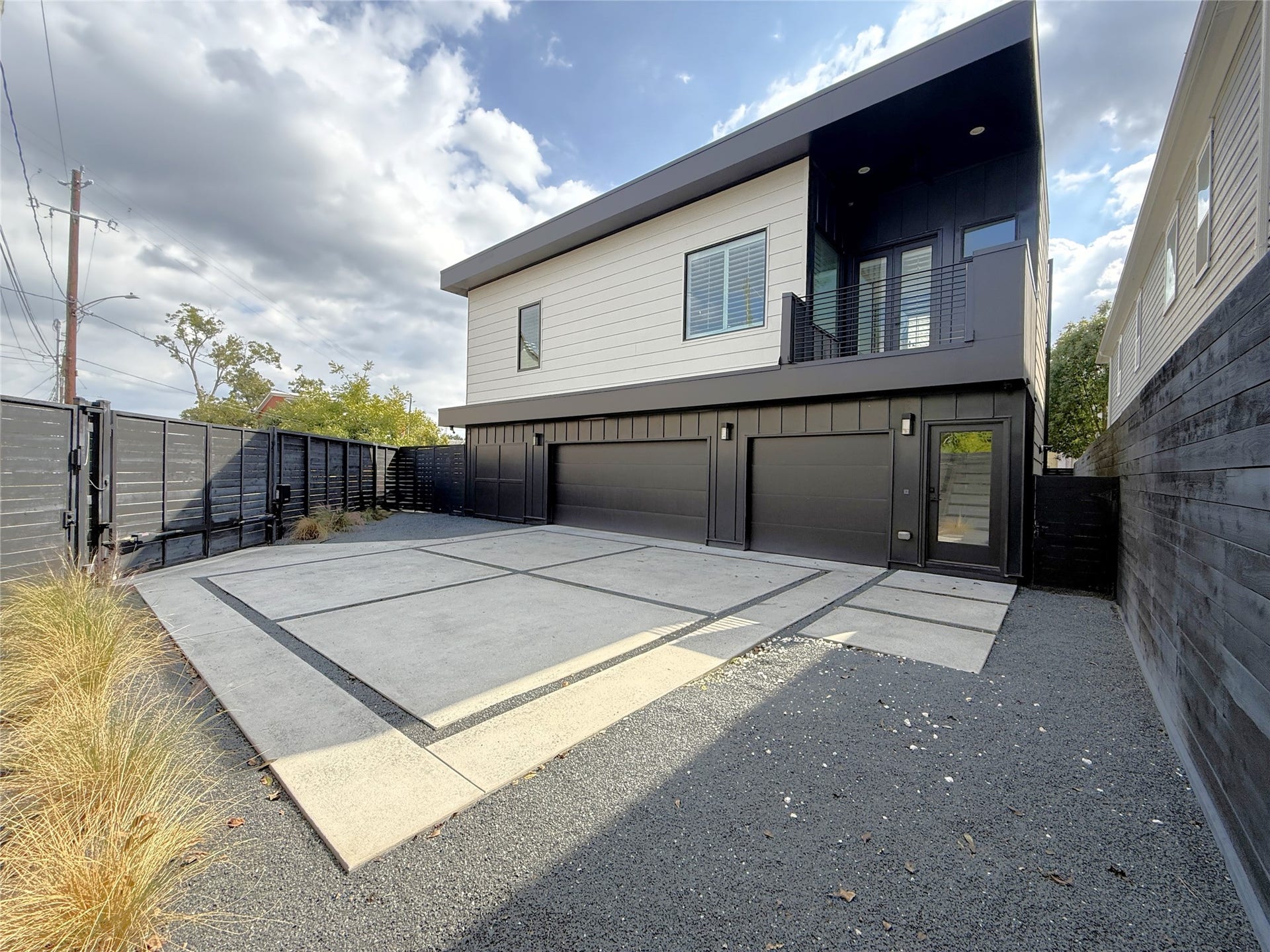 Sleek & modern! There is enough parking beyond the gate for a guest vehicle.