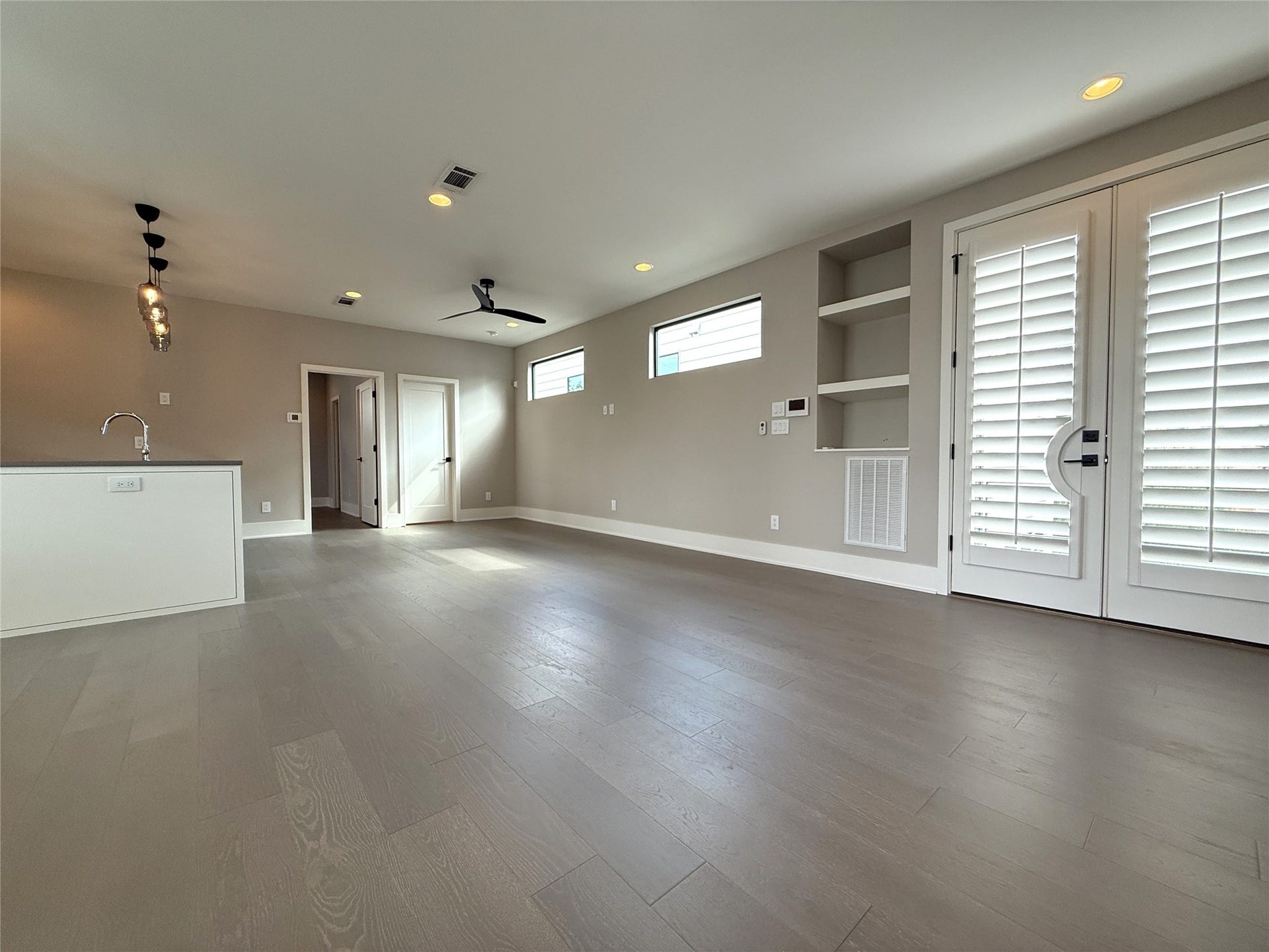 Picture taken from the dining space, French doors open in from the second balcony. Notice the built-in book/display shelves.