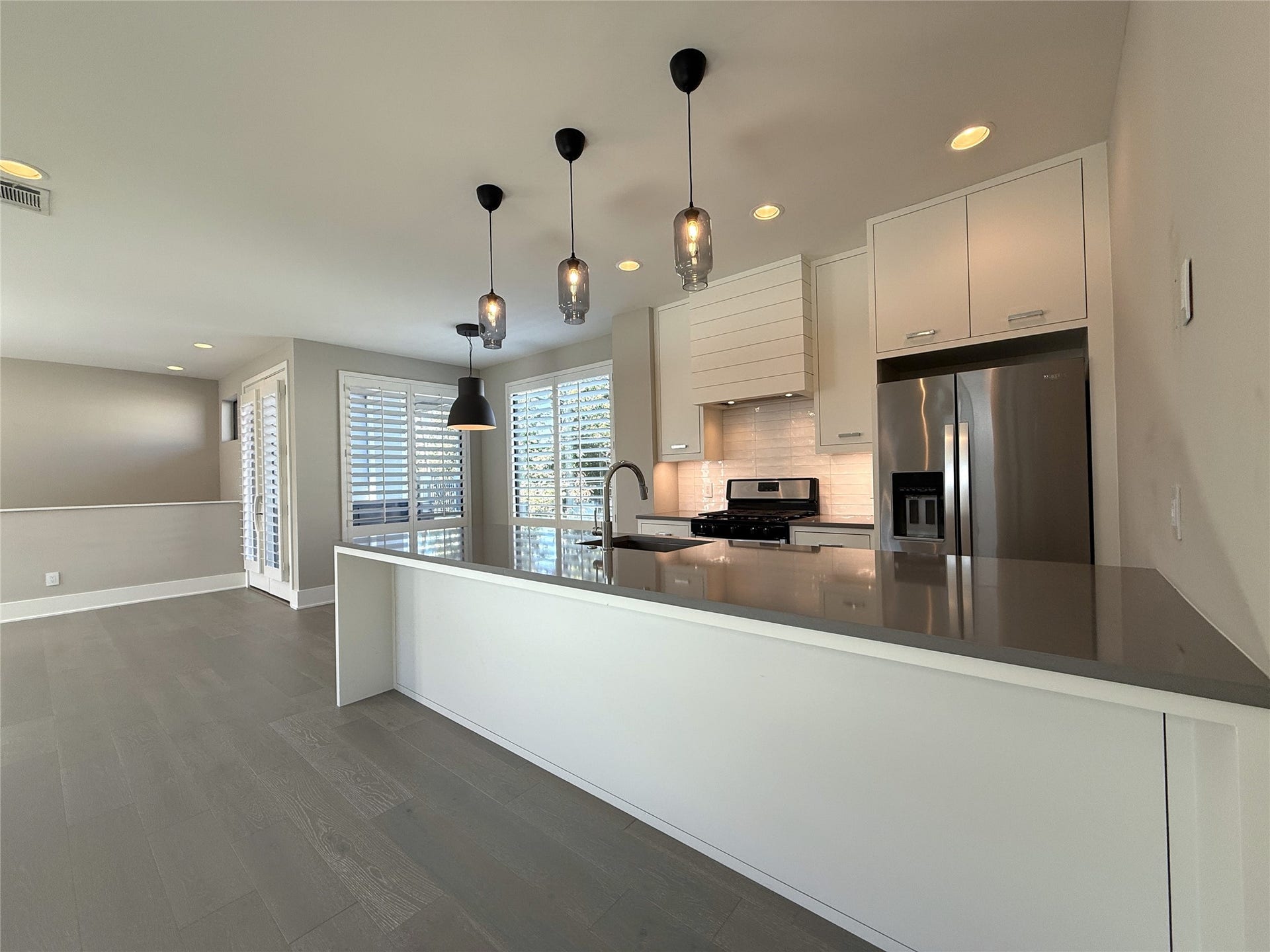 Absolutely beautiful kitchen! With pendant lighting overhead, the extended breakfast bar offers enough space for several bar stools.