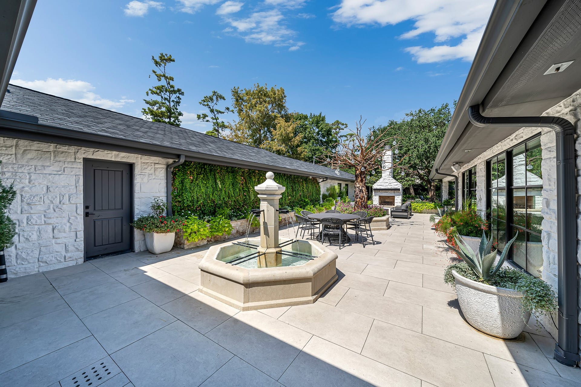 Courtyard area with imported French water fountain and outdoor fireplace. The perfect setting to enjoy an outdoor glass of wine or entertain guests.