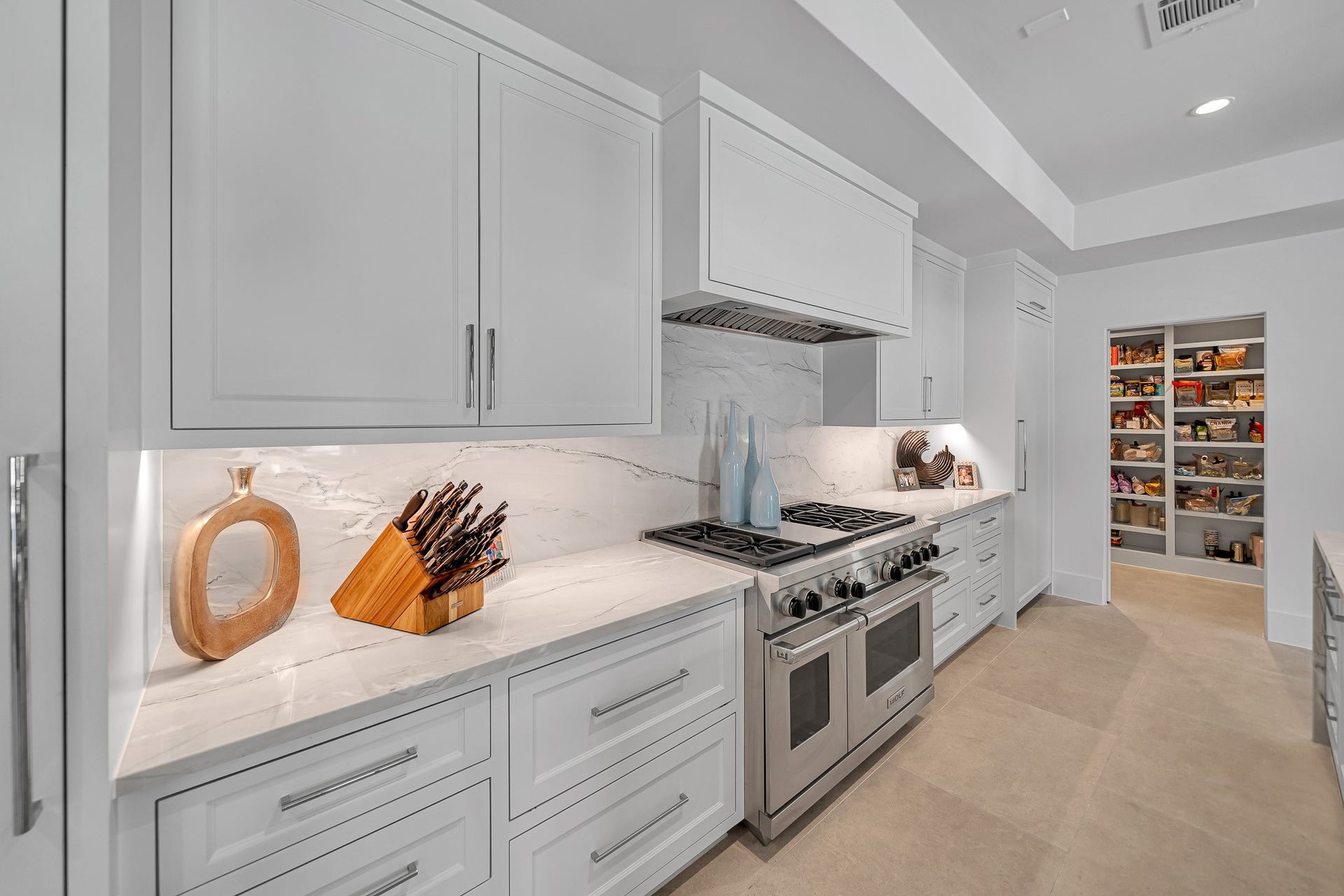 Quartzite backsplash throughout kitchen. Wolf oversized 40" renaissance gas grill.