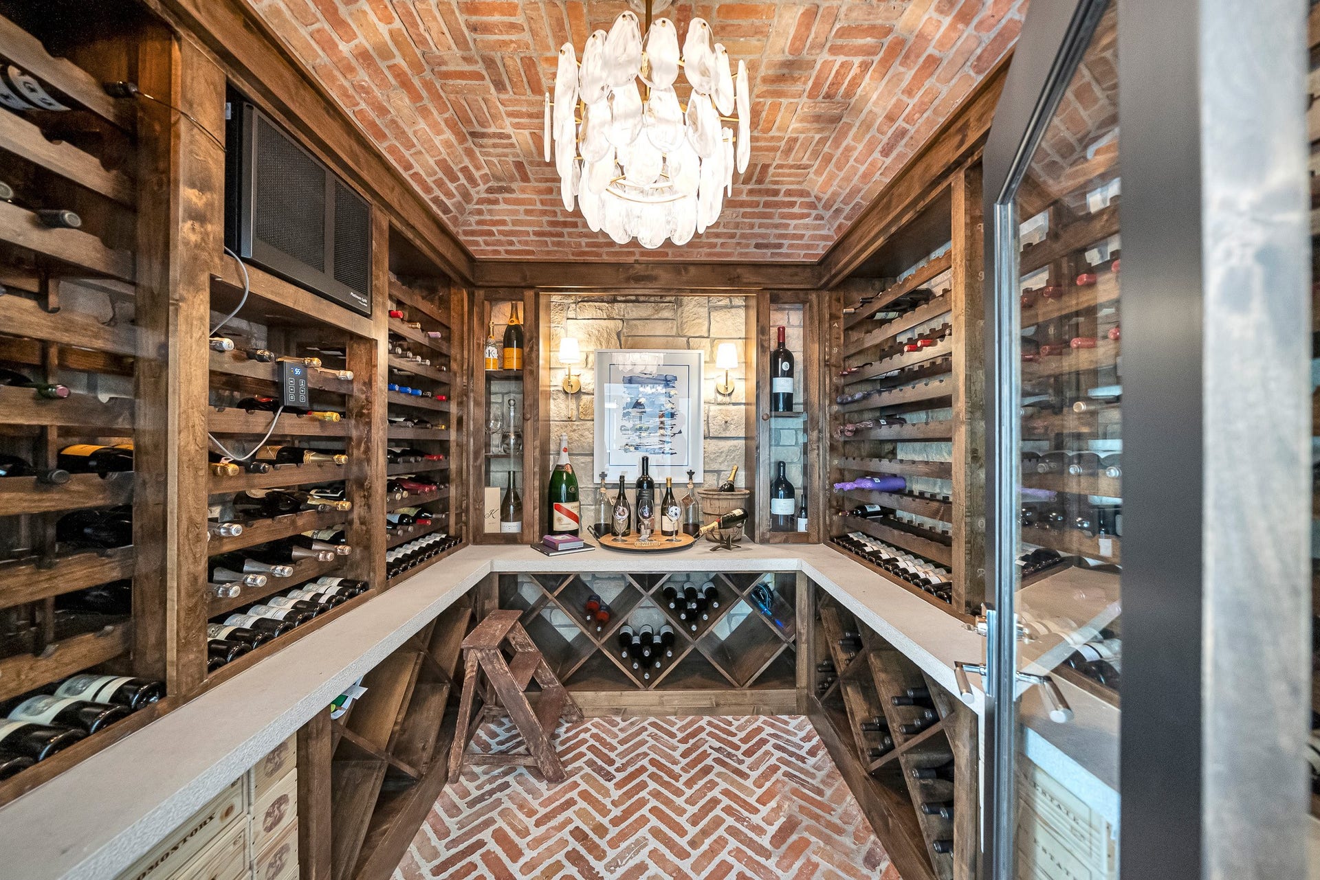 A stunning temperature-controlled wine room designed to beautifully showcase and preserve a collection of up to 500 bottles.