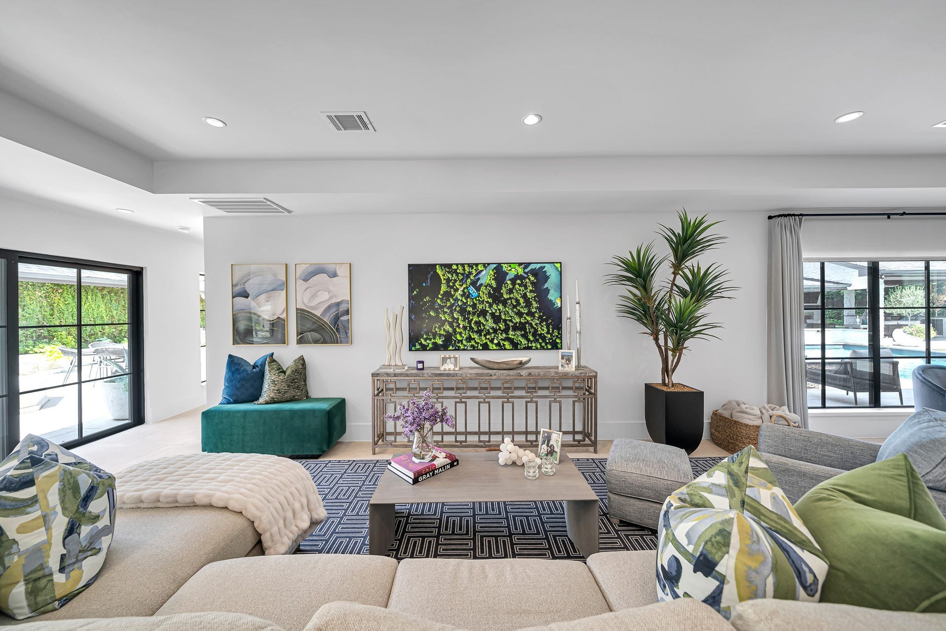 Relax or simply enjoy this inviting open living space, offering beautiful views of the courtyard and swimming pool.