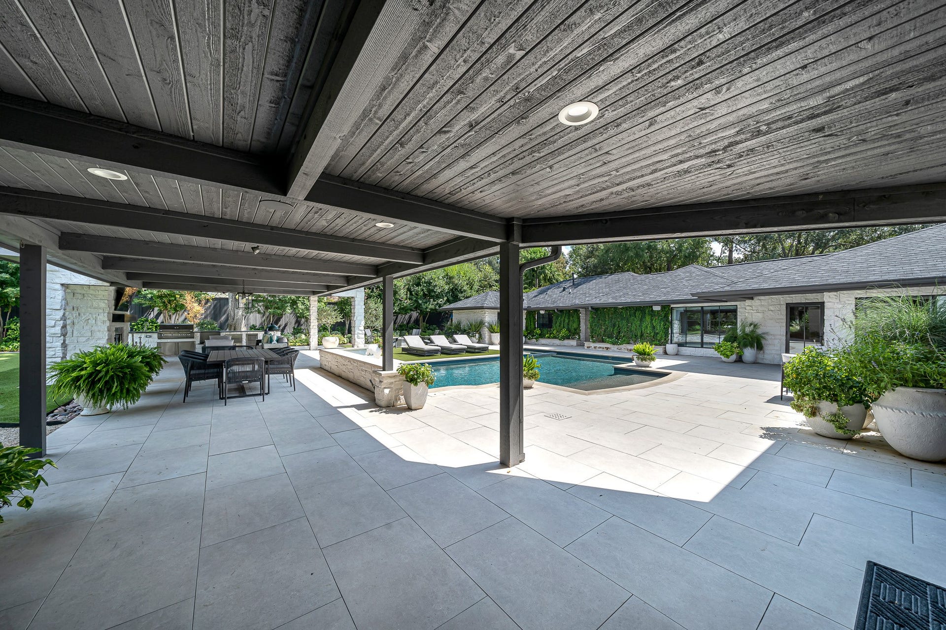 Fully covered patio with outdoor kitchen and green egg grill. Not to mention the backyard is equipped with a mosquito sprayer system