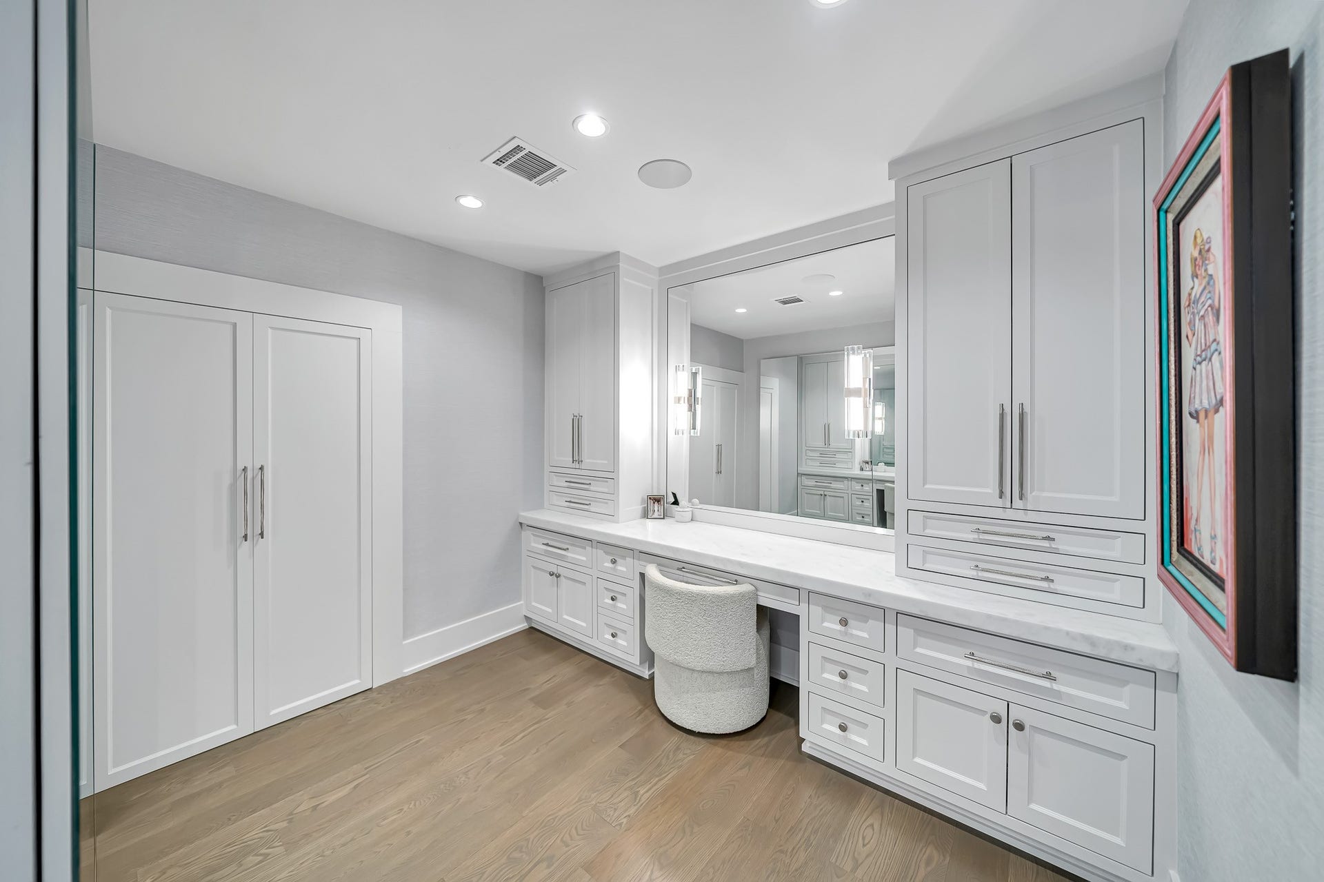 Vanity area offers dedicated space to get ready with refined feel that compliments the primary suite. Behind the double doors is a saferoom with inswing vaulted door.