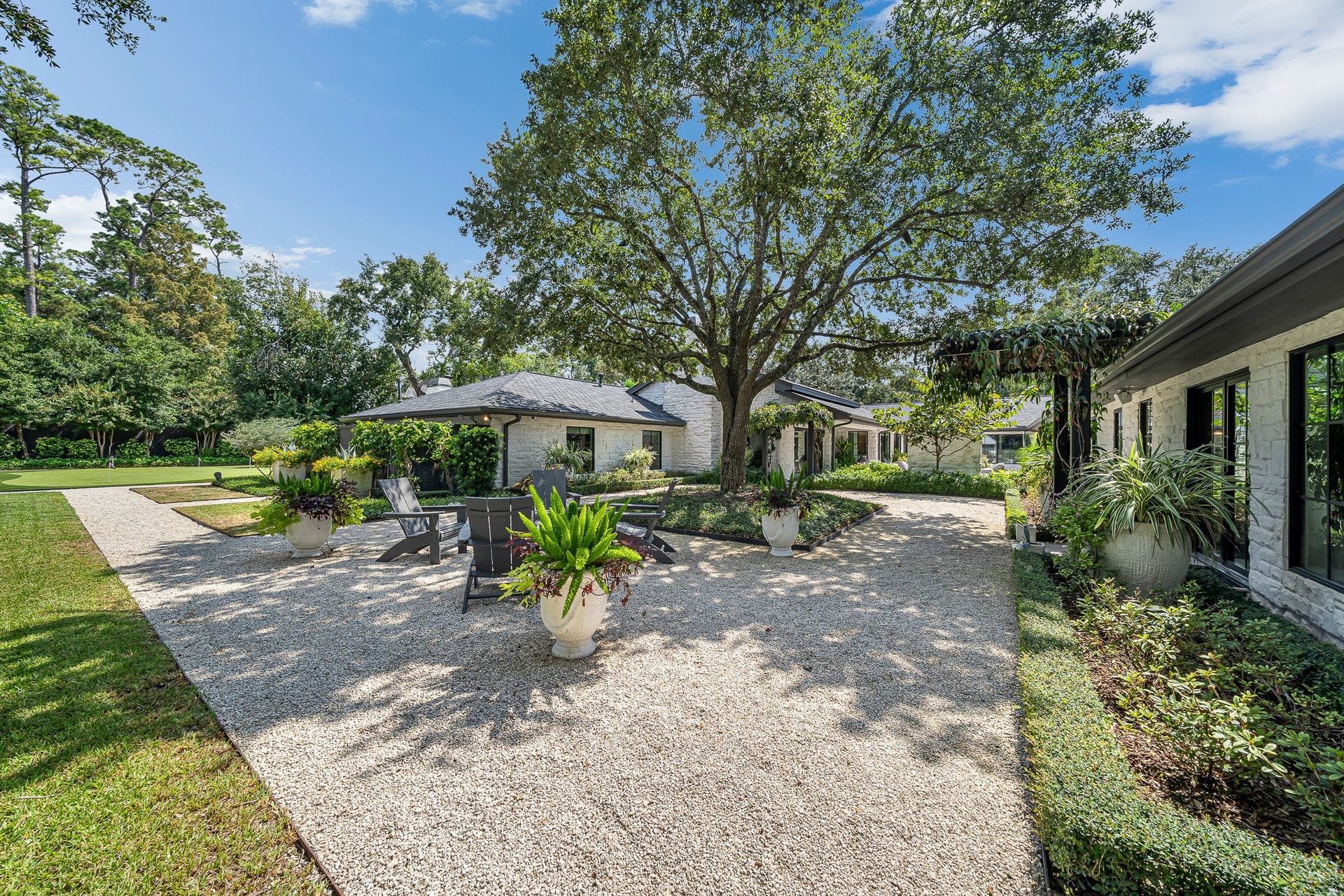 Mature landscaping and vibrant foliage frame the home beautifully, creating a resort like setting.