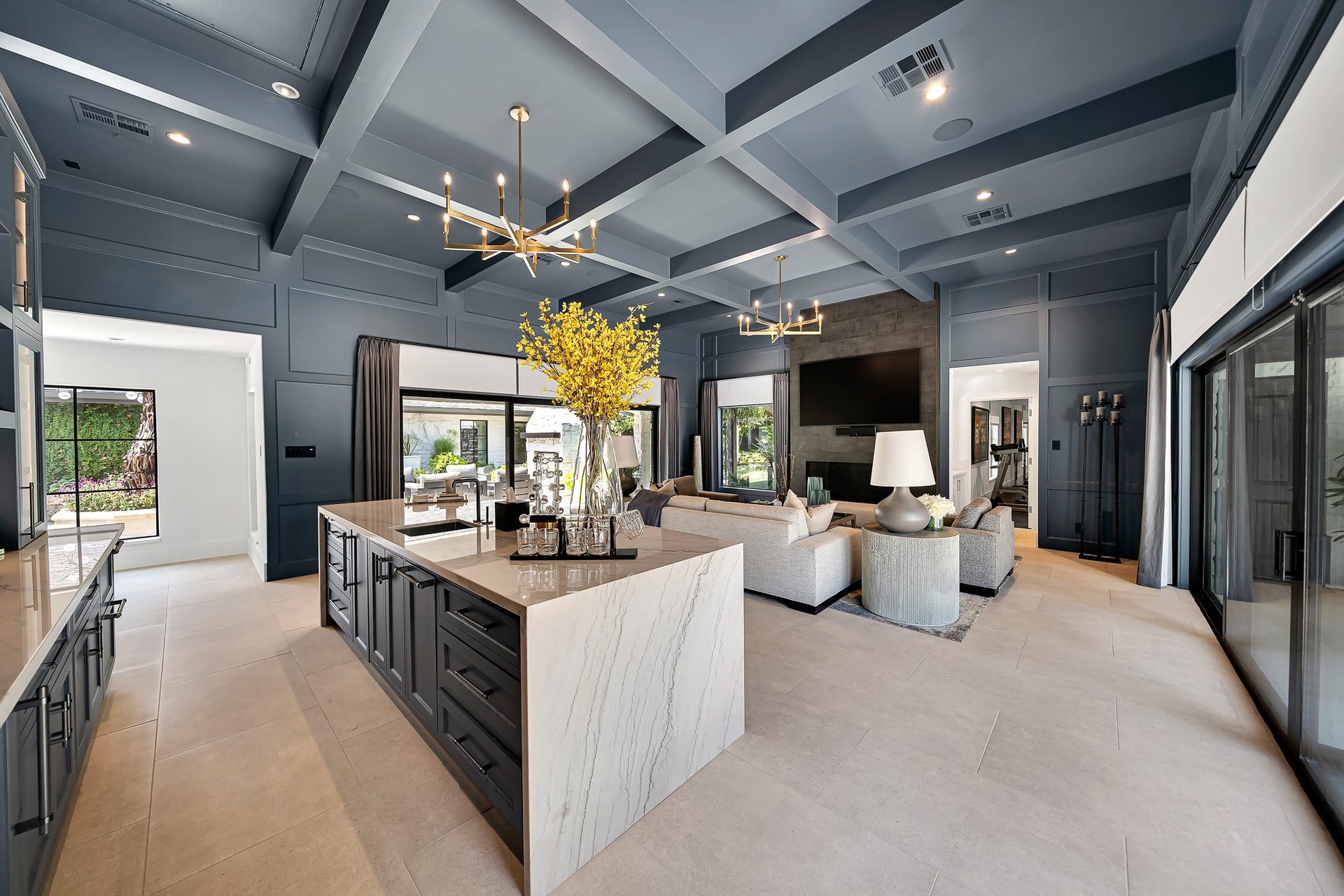 The lounge area is anchored by a striking fireplace with expansive views of the beautifully landscaped outdoors.