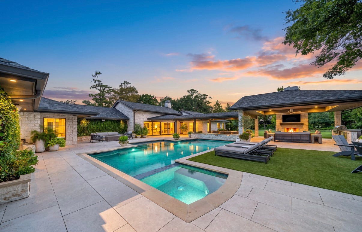 Luxurious backyard oasis featuring a sparkling pool, spacious patio, and outdoor living area with a cozy fireplace, all set against a stunning sunset backdrop.