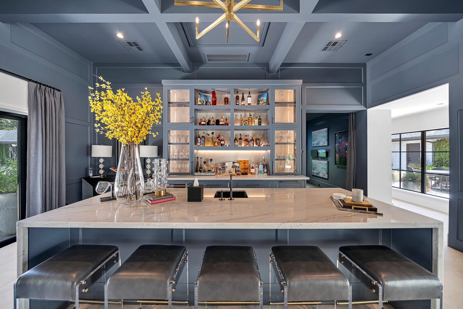 Sophisticated lounge area with full bar creating the perfect setting for entertaining guests.