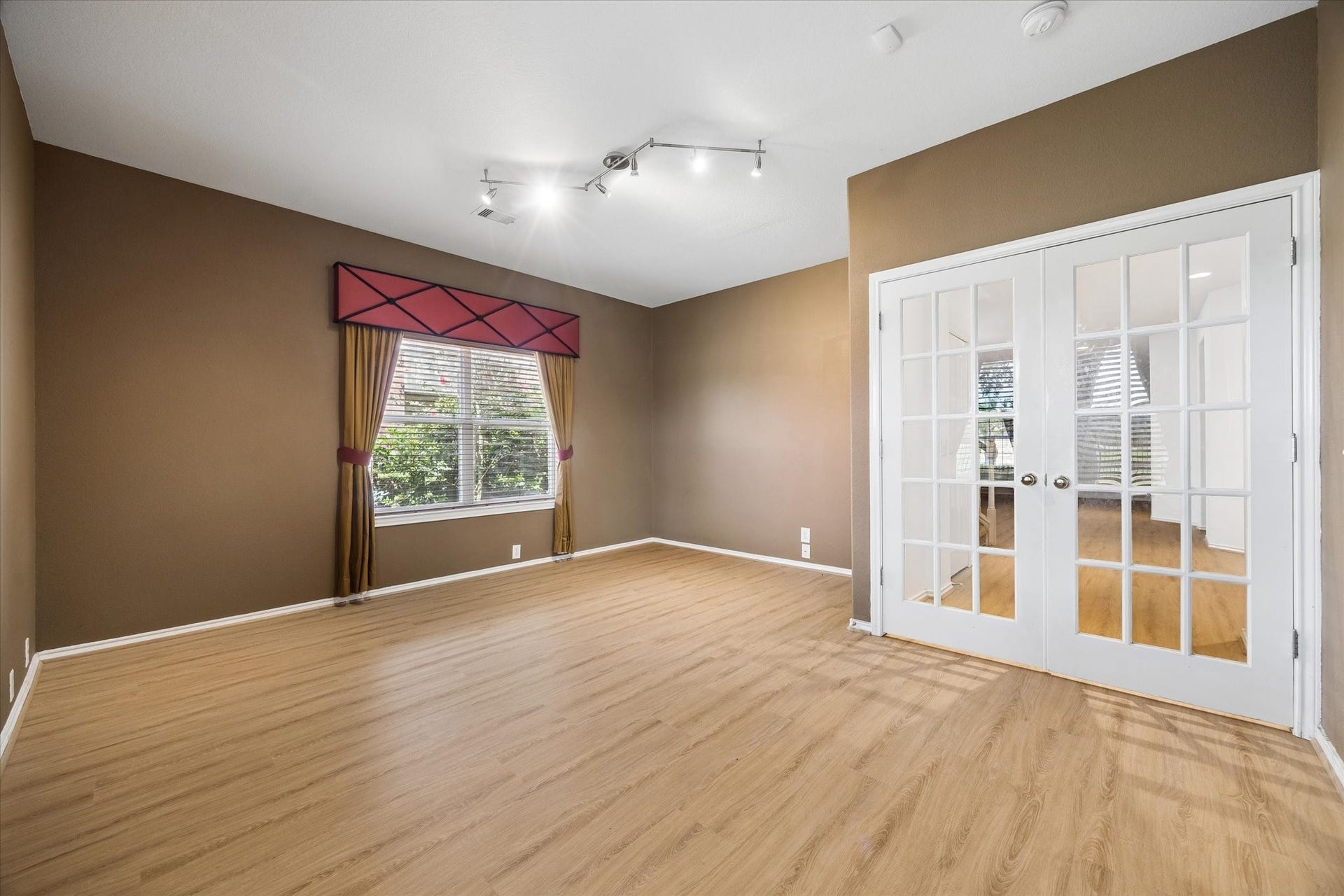 Spacious office or bedroom on the first floor with a large walk-in closet and a full bathroom just outside the room.