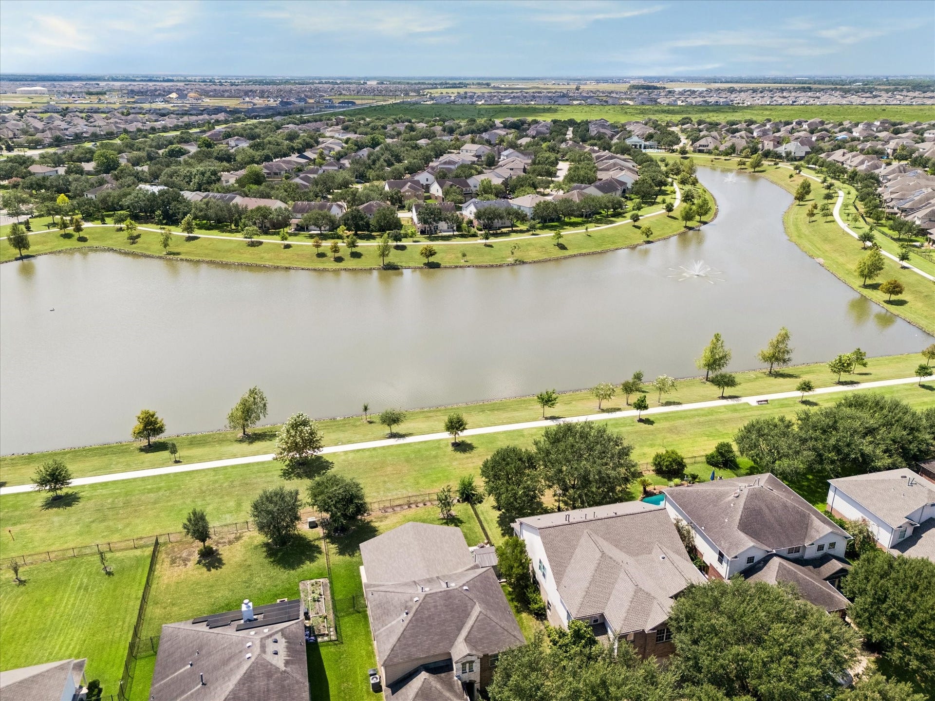 Discover serene lakeside living in a vibrant community, featuring picturesque walking paths and lush greenery, perfect for outdoor enthusiasts.  Enjoy this view from your back patio.