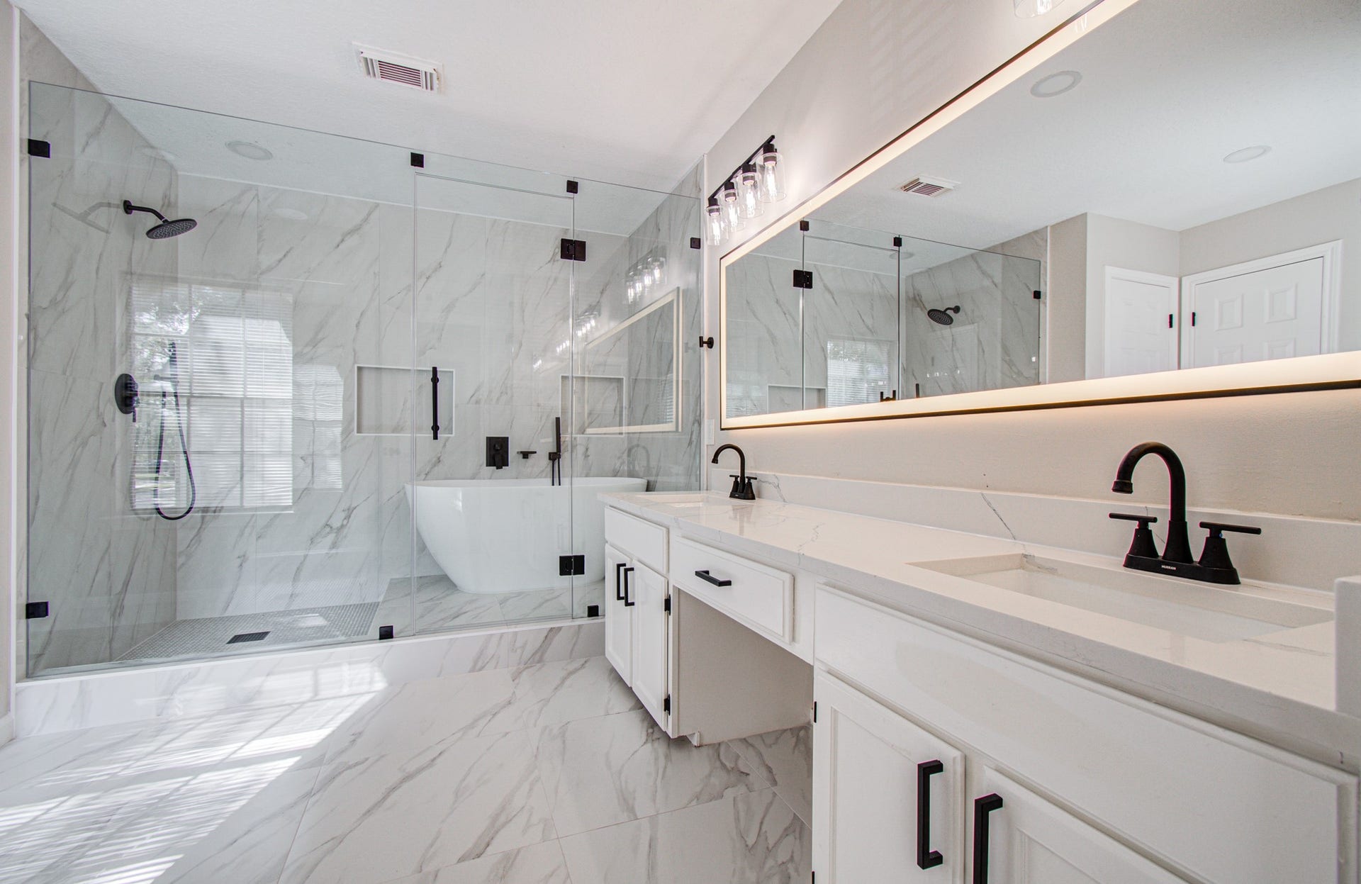 2934 Plantation Wood Lane, Missouri City, TX 77459 Spa Inspired primary bath featuring dual sink, designer lighting, quartz countertop, stand-alone tub and LED mirror