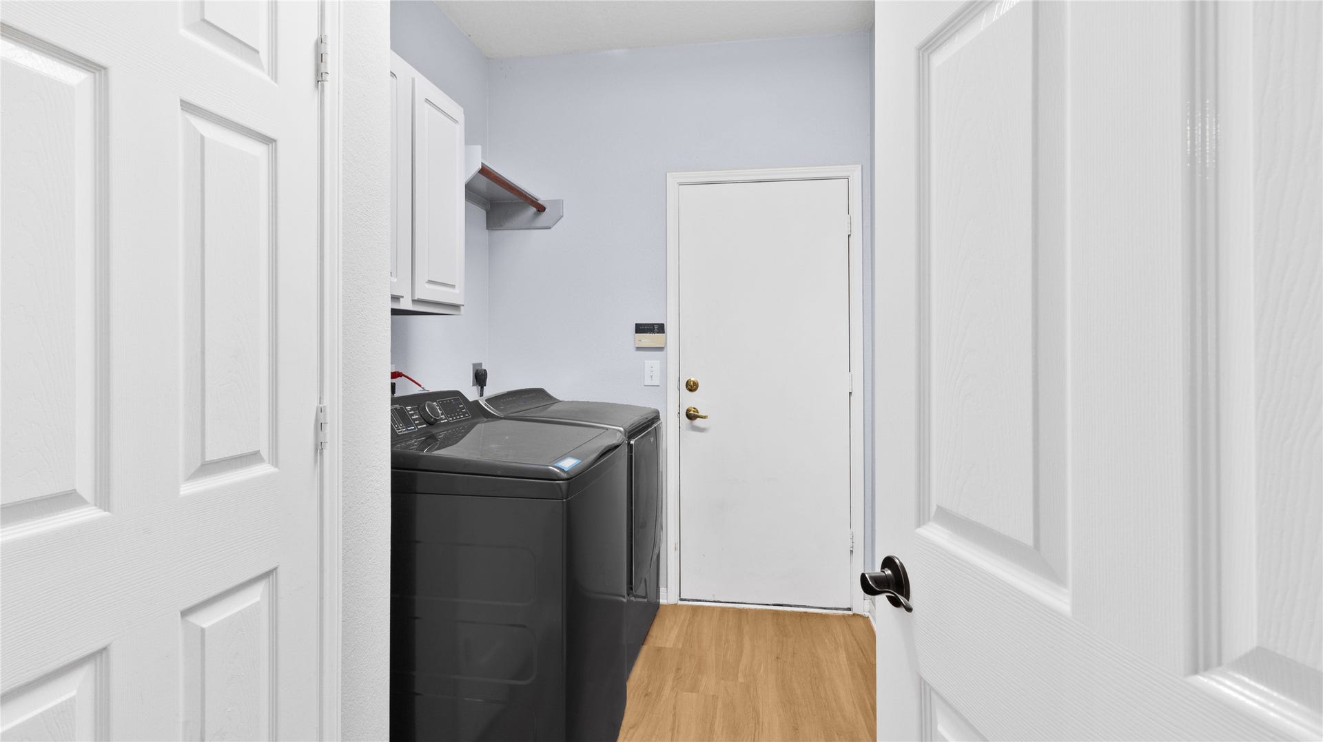 20214 Powerscourt Drive, Humble, TX 77346 Tucked away for convenience, the laundry room features clean white cabinetry and easy access to the attached garage