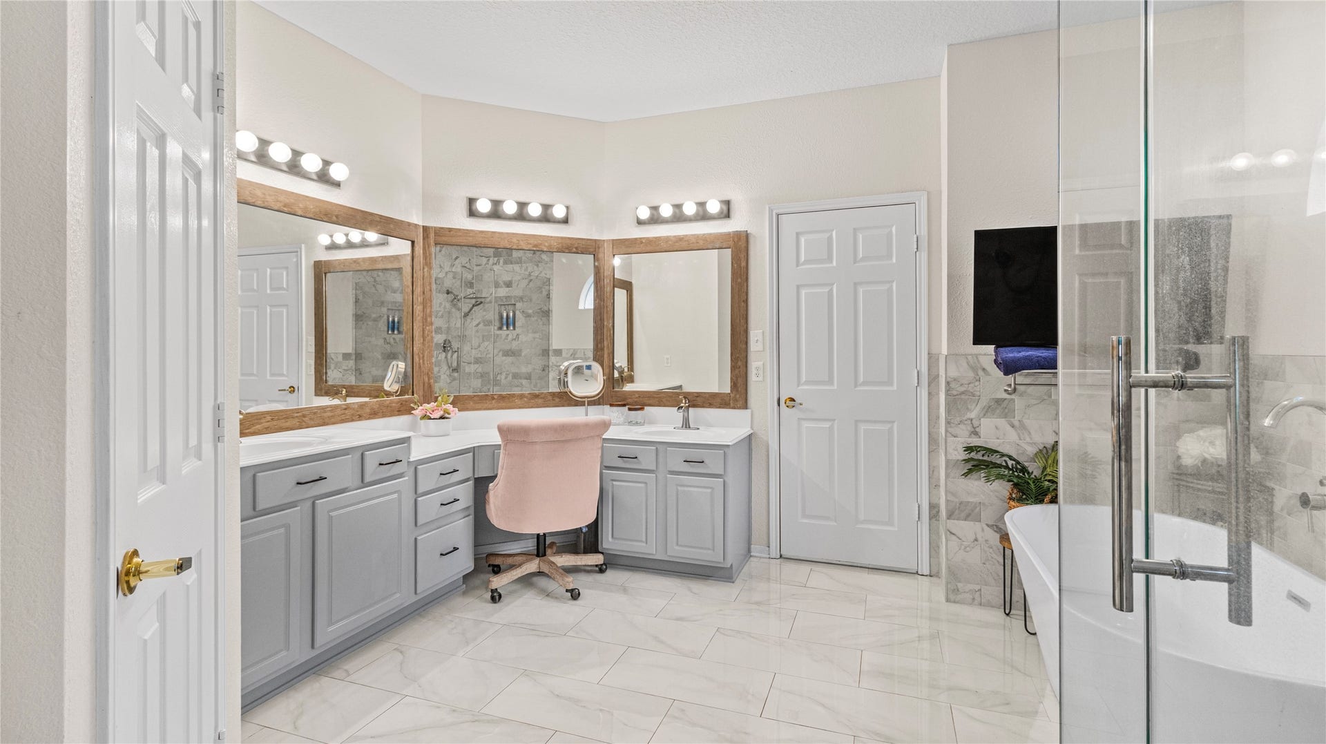 20214 Powerscourt Drive, Humble, TX 77346 Spa-like elegance: this renovated ensuite boasts dual vanities, contemporary fixtures, and a serene atmosphere designed for relaxation.