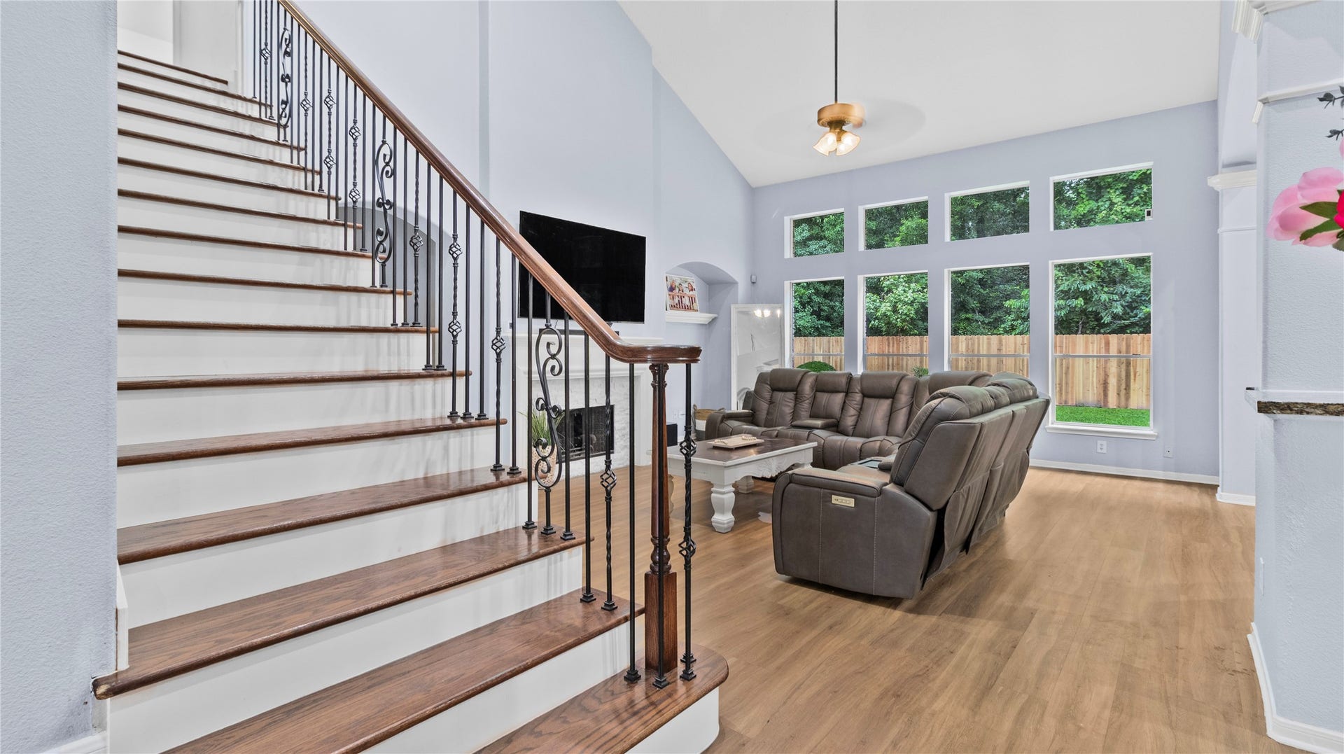 20214 Powerscourt Drive, Humble, TX 77346 An elegant first impression: the open-concept living area features a stunning updated staircase with wrought-iron spindles and rich wood treads