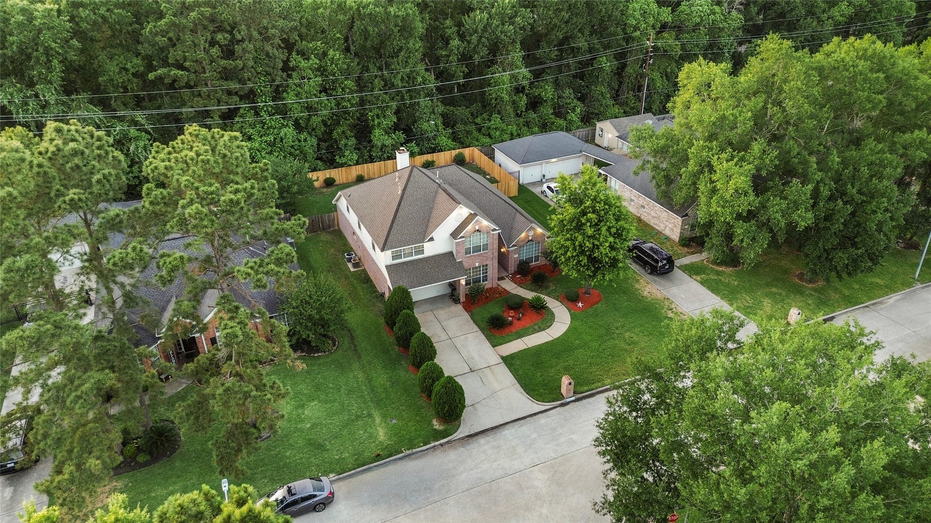 20214 Powerscourt Drive, Humble, TX 77346 A wide-angle view of the property showing the lush green lawn and established landscaping that frames the home perfectly.