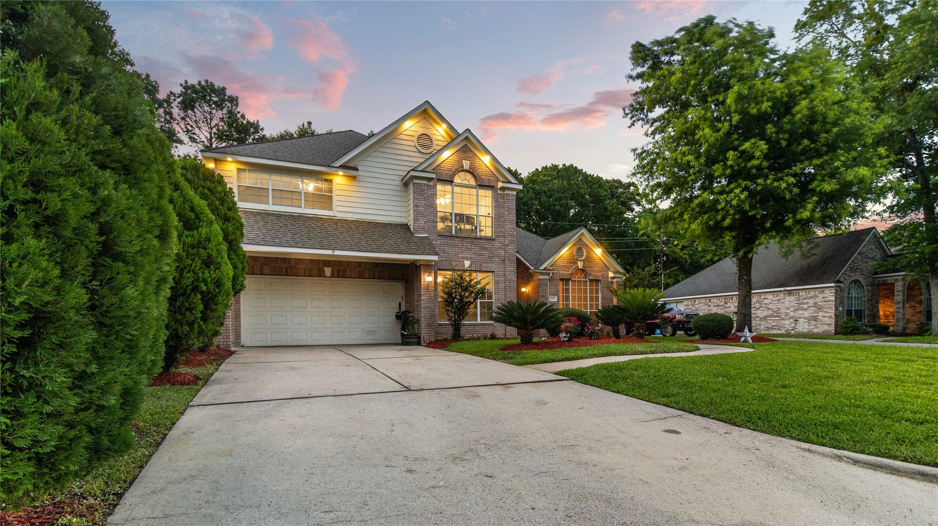 20214 Powerscourt Drive, Humble, TX 77346 This property truly shines at dusk, offering a warm and sophisticated welcome to those seeking their next perfect home.