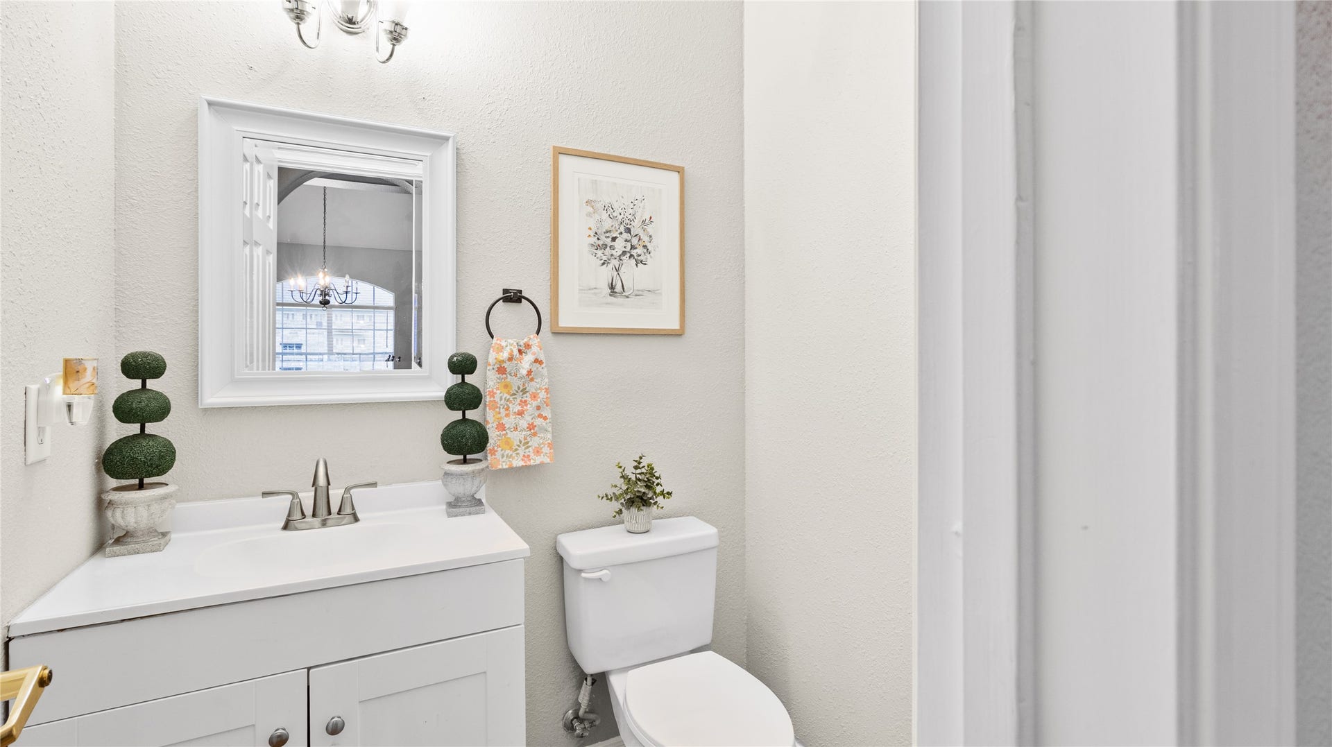 20214 Powerscourt Drive, Humble, TX 77346 Powder Room: A cozy and stylish half-bath featuring a modern vanity with a sleek faucet and bright, clean finishes