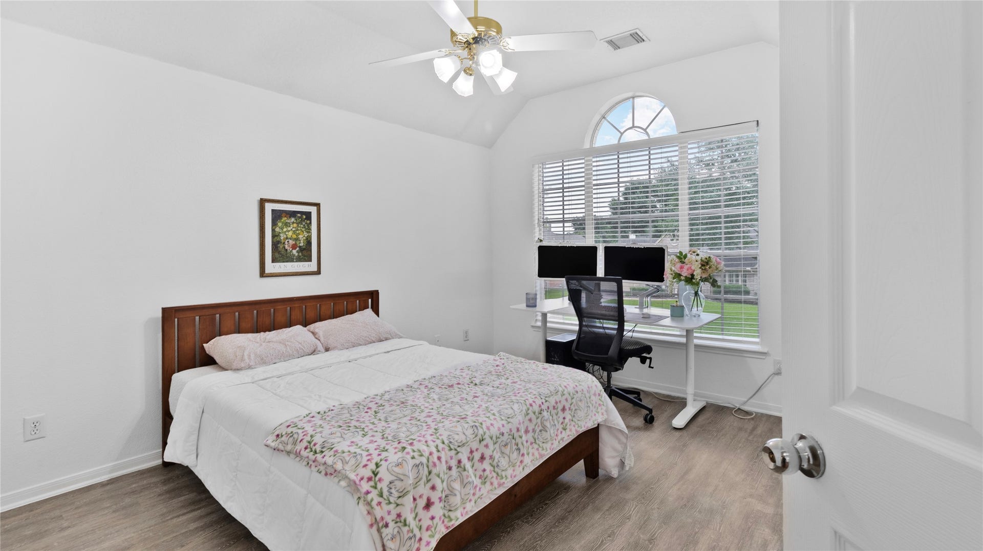 20214 Powerscourt Drive, Humble, TX 77346 Soaring ceilings and charm abounds in this upstairs bedroom, centered around a stunning oversized arched window that floods the space with natural light.