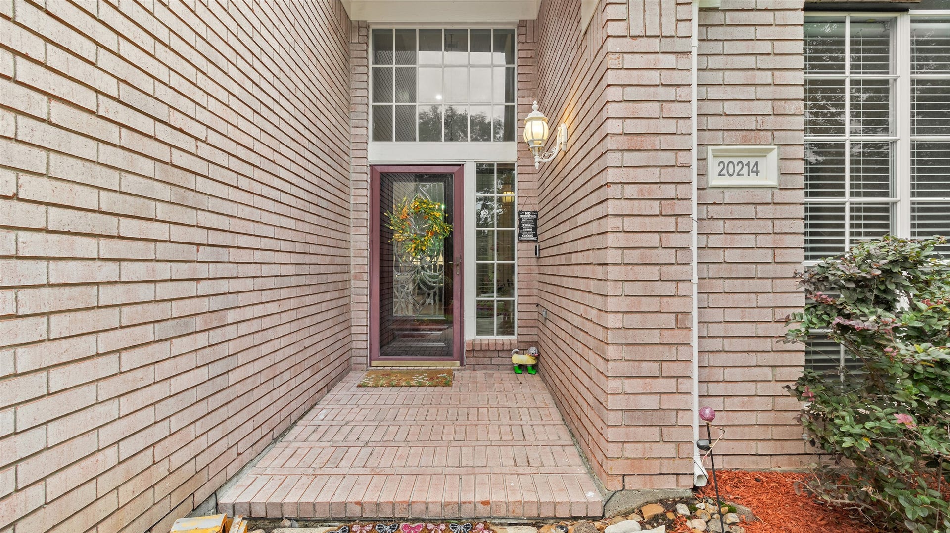 20214 Powerscourt Drive, Humble, TX 77346 The covered front porch offers a warm, inviting feel with its classic exterior lighting and beautiful curb appeal