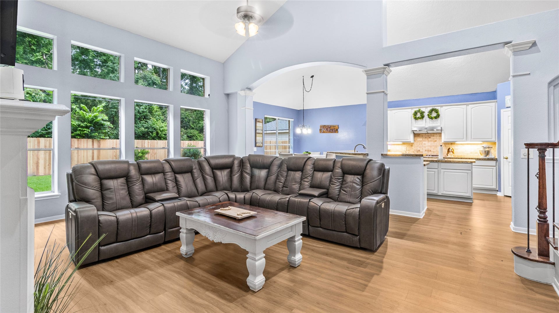 20214 Powerscourt Drive, Humble, TX 77346 Bask in the natural light of the main living area, featuring soaring ceilings and a wide-angle view of the newly fenced, private backyard.