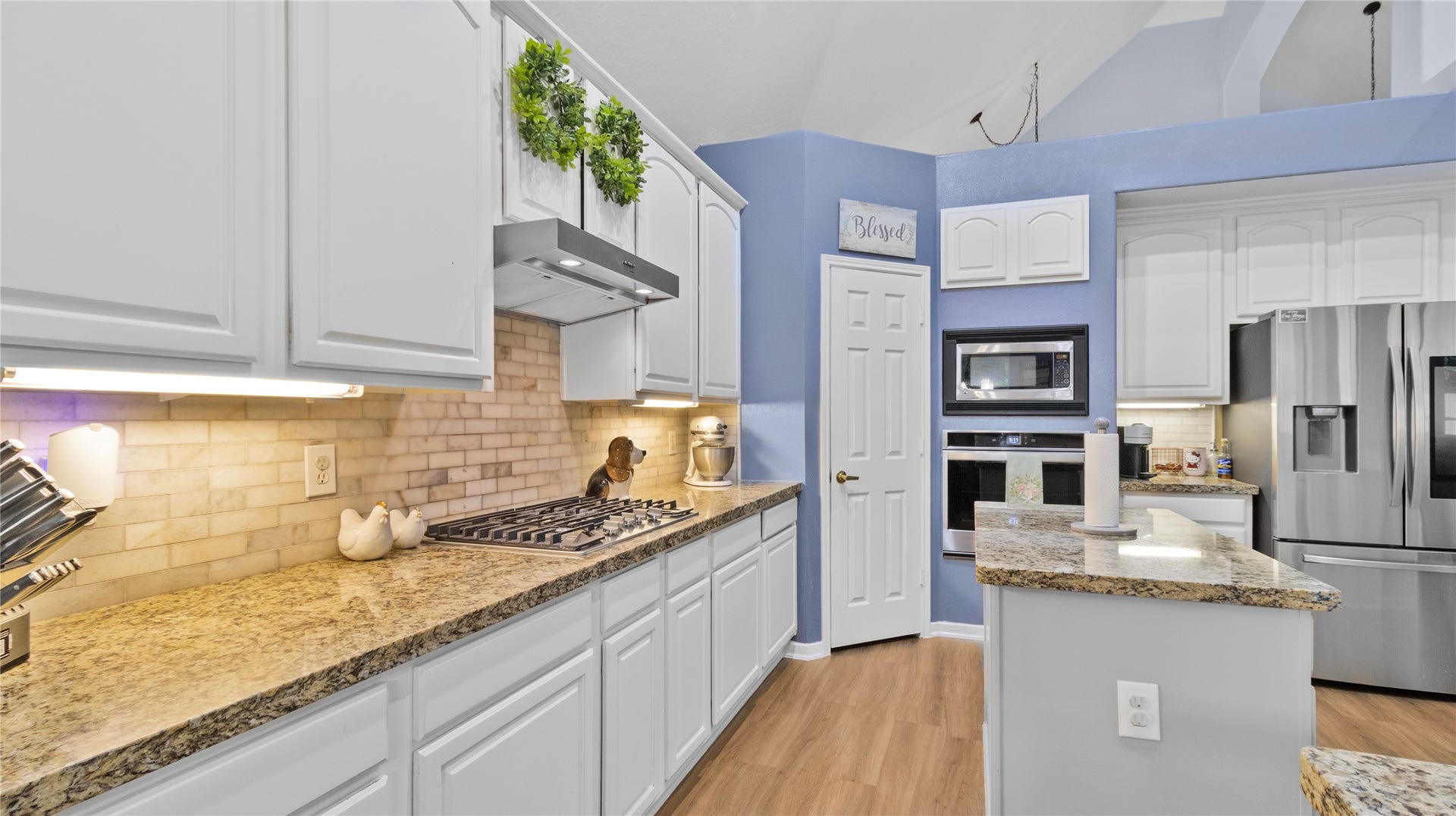 20214 Powerscourt Drive, Humble, TX 77346 Detail view of the sleek granite countertops and ample storage, perfectly complemented by under-cabinet lighting for a bright, functional workspace