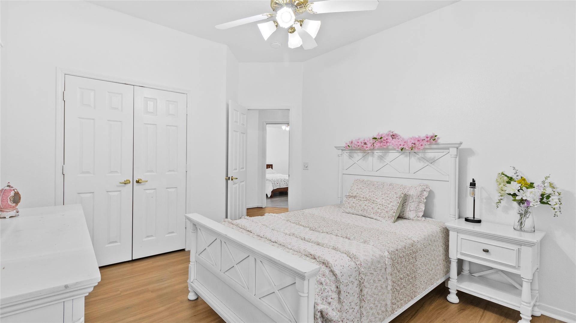 20214 Powerscourt Drive, Humble, TX 77346 Another bright and airy upstairs bedroom featuring warm wood flooring, a cooling ceiling fan, and plenty of closet space