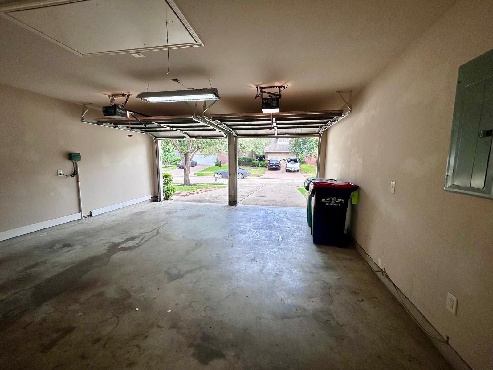 25918 Silver Timbers Lane, Katy, TX 77494 Elegant kitchen with rich wood cabinetry, a sleek black oven and microwave, and a modern gas cooktop, complemented by a stylish tile backsplash.