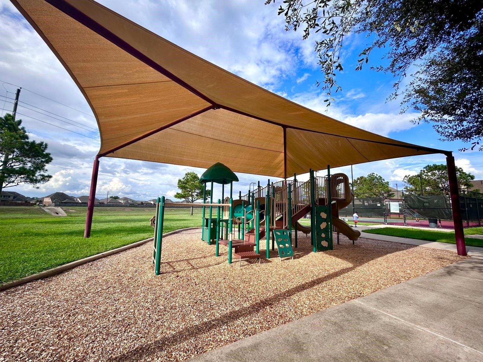 25918 Silver Timbers Lane, Katy, TX 77494 Charming community playground featuring a shaded play structure, perfect for family fun and relaxation amidst lush greenery.