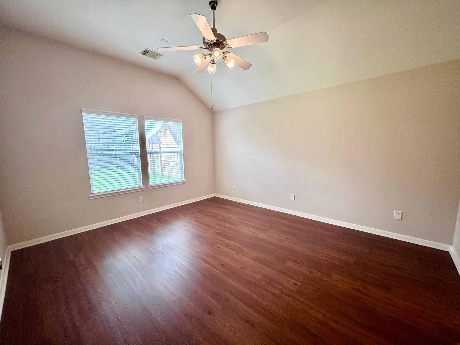 25918 Silver Timbers Lane, Katy, TX 77494 Spacious room with elegant wood flooring, a vaulted ceiling, and large windows offering plenty of natural light.