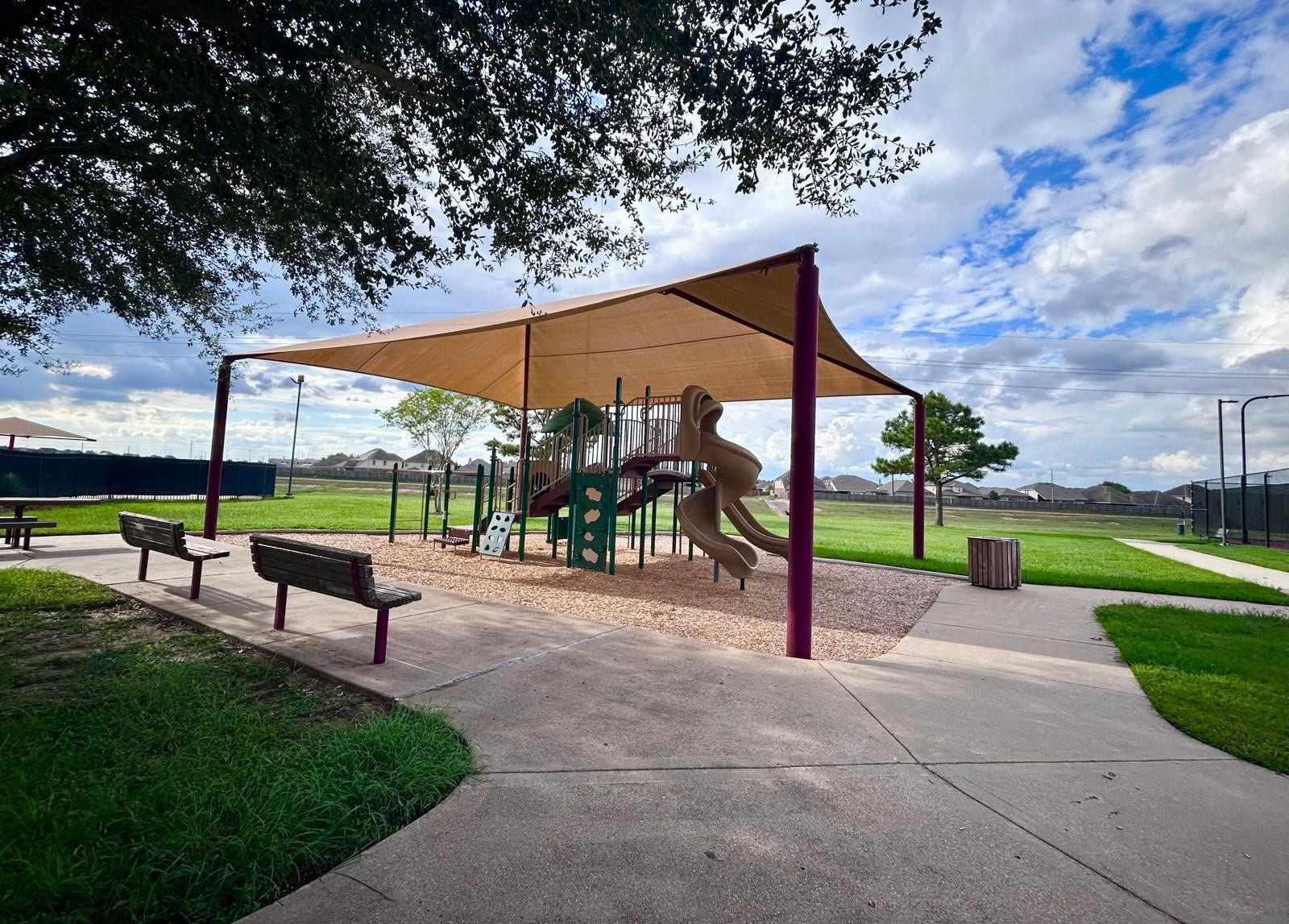 25918 Silver Timbers Lane, Katy, TX 77494 Community playground with modern equipment, shaded seating, and surrounding green space is great for playing and enjoying the outdoors.