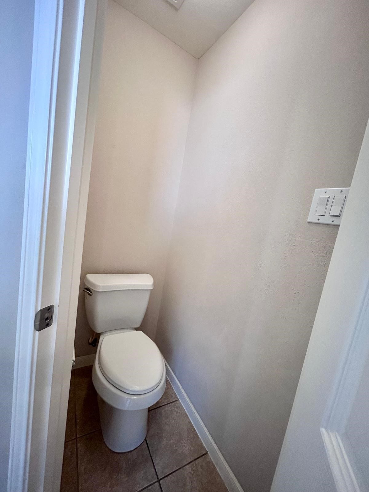 25918 Silver Timbers Lane, Katy, TX 77494 Cozy powder room with tile flooring and neutral walls, offering a functional and efficient use of space.