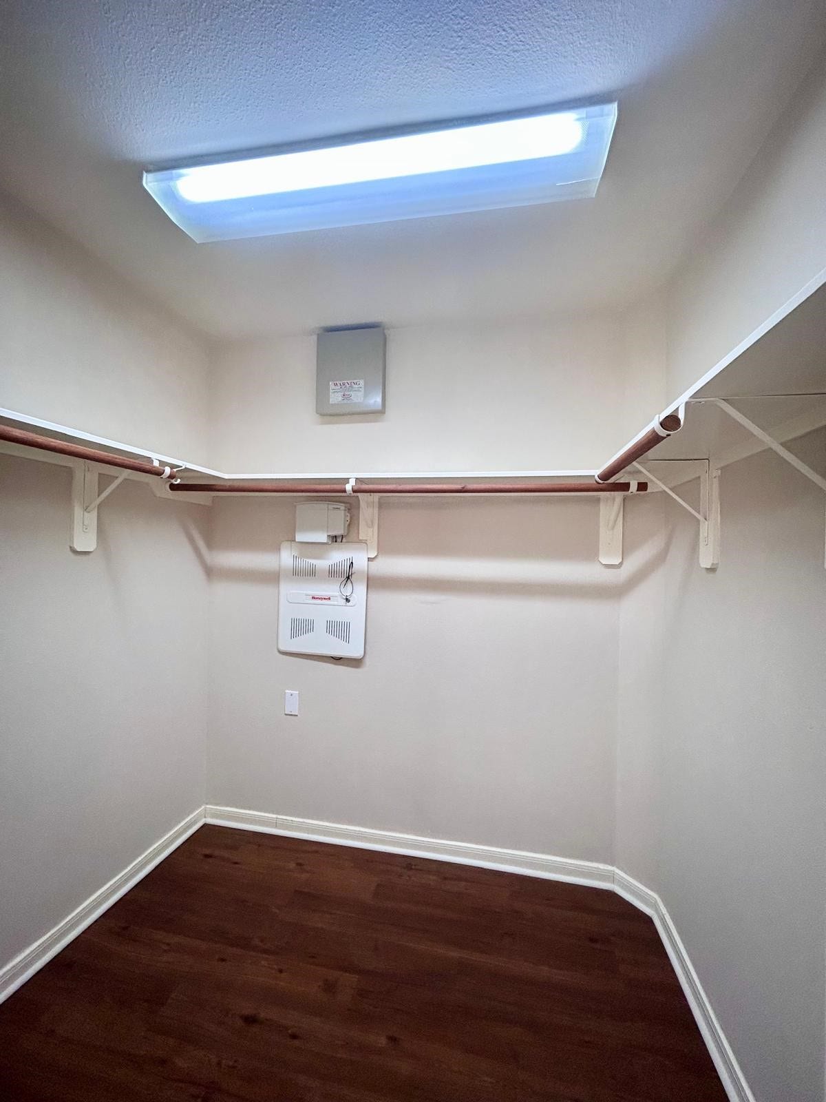 25918 Silver Timbers Lane, Katy, TX 77494 Spacious walk-in closet with ample hanging space and warm wood flooring, perfect for organizing your wardrobe.