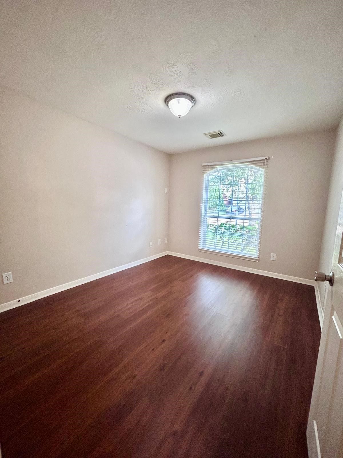 25918 Silver Timbers Lane, Katy, TX 77494 Bright room with elegant wood flooring and a large window offering plenty of natural light.