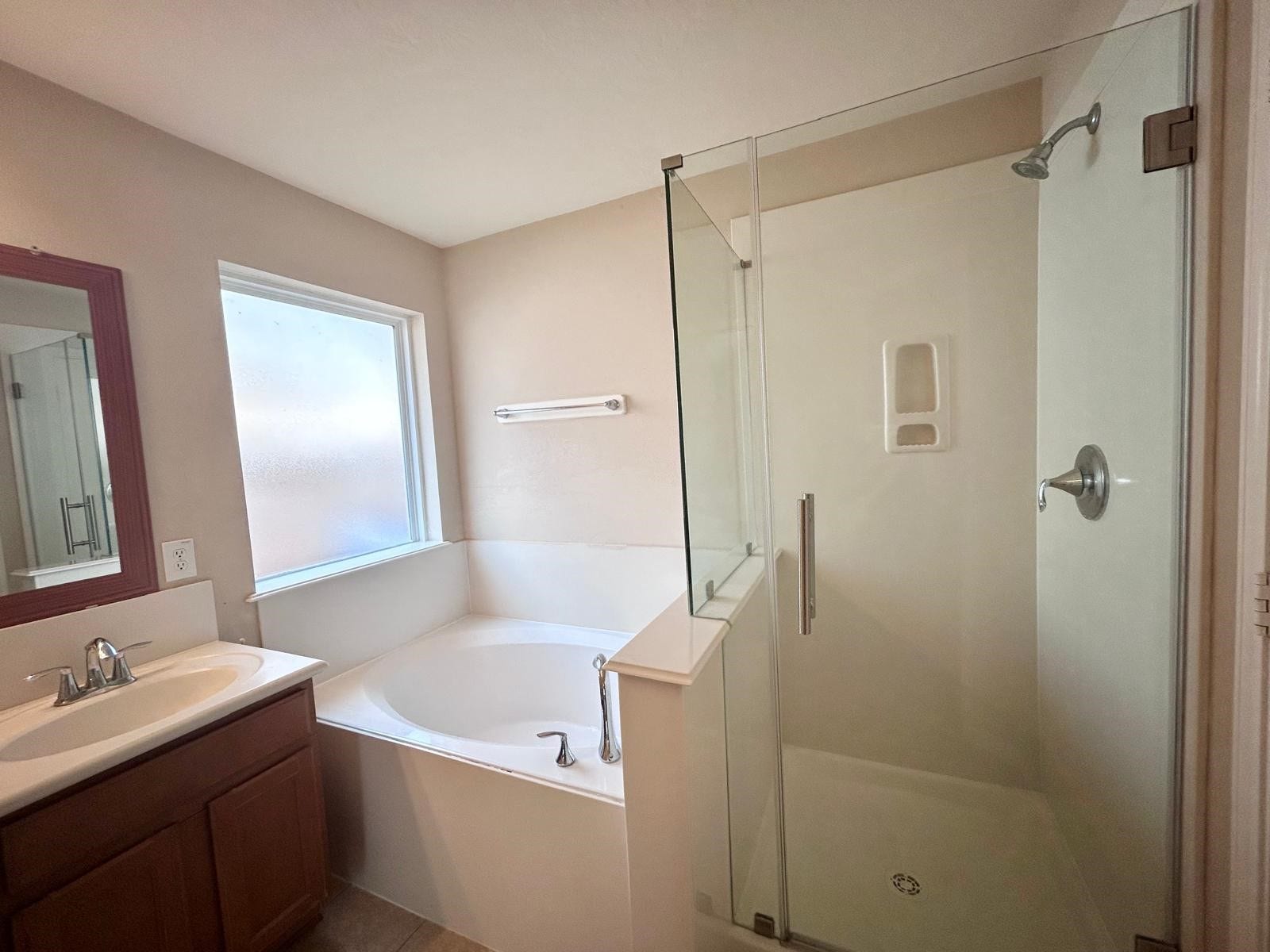25918 Silver Timbers Lane, Katy, TX 77494 Bright and inviting bathroom featuring a luxurious soaking tub, sleek glass-enclosed shower, and a vanity with ample storage.
