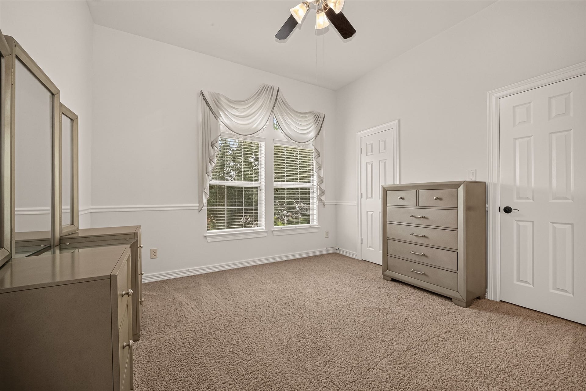 1814 Bartrum Street, Sugar Land, TX 77479 Bright and inviting bedroom with plush carpeting, elegant window treatments, and ample natural light.