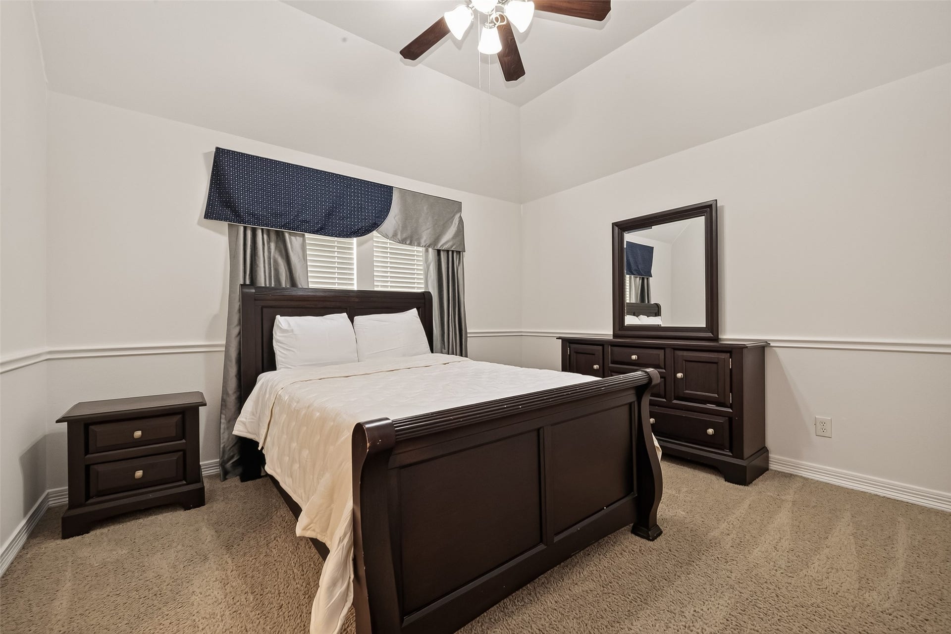 1814 Bartrum Street, Sugar Land, TX 77479 Bedroom with elegant dark wood furniture, plush carpeting, and soft natural light filtering through classic window treatments.