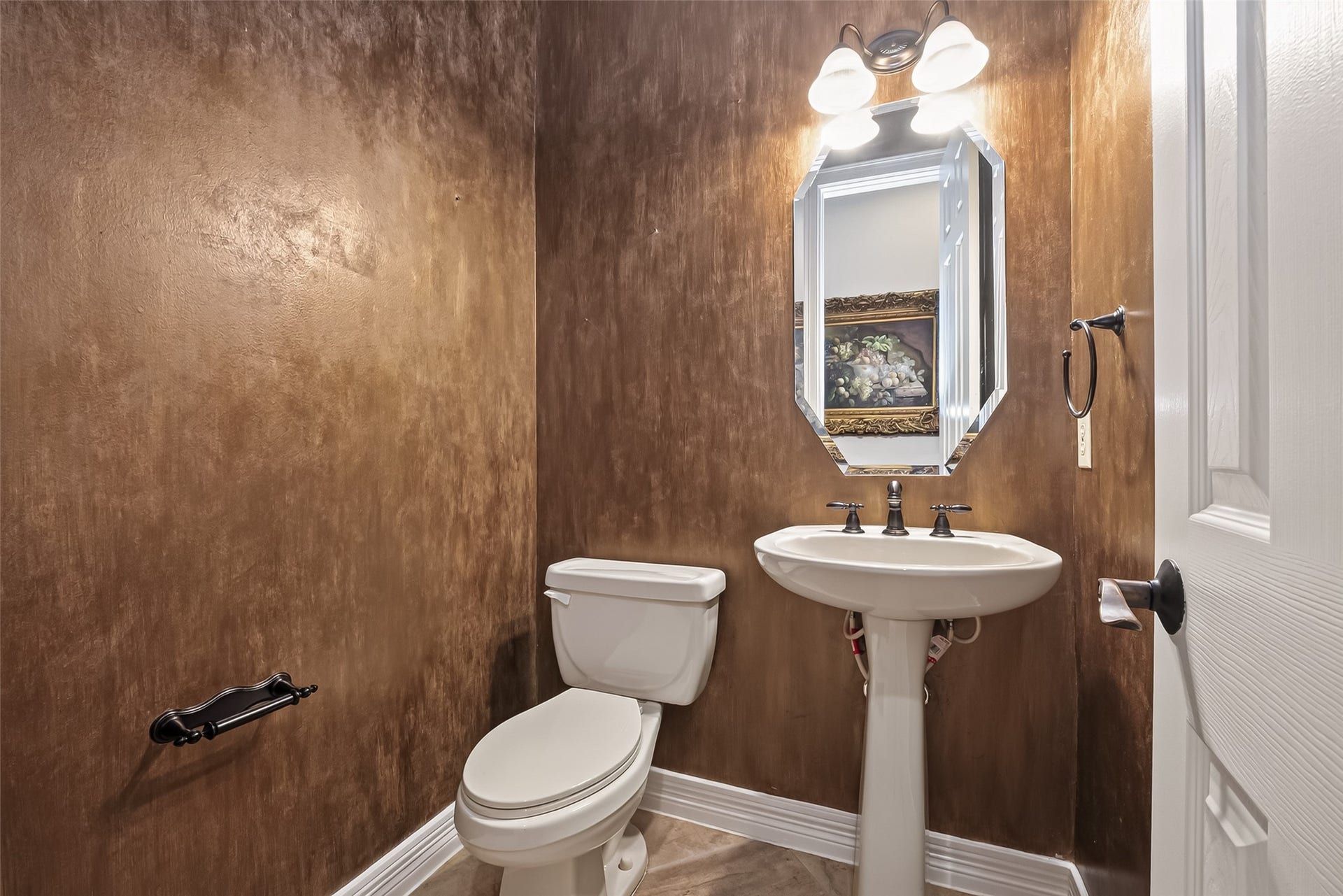 1814 Bartrum Street, Sugar Land, TX 77479 Elegant powder room featuring rich, textured brown walls, a classic pedestal sink, stylish framed mirror, decorative lighting, and classic fixtures, creating a warm and inviting atmosphere