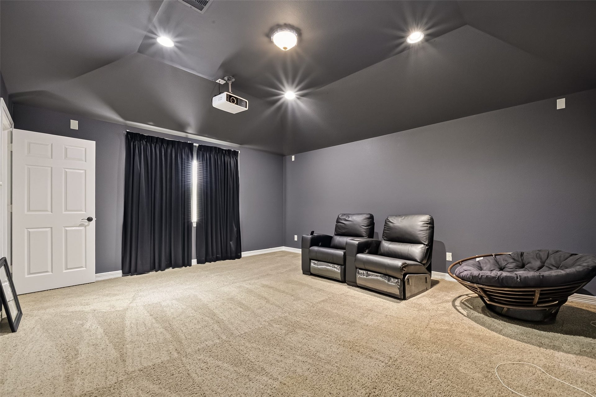 1814 Bartrum Street, Sugar Land, TX 77479 Experience the ultimate home theater experience in this spacious media room, featuring plush recliners, a cozy lounge chair, and a state-of-the-art projector for cinematic viewing.